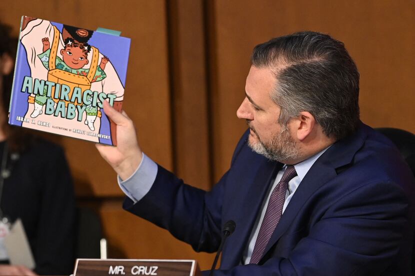 Sen. Ted Cruz holds a book titled "Antiracist Baby" while speaking during the confirmation...