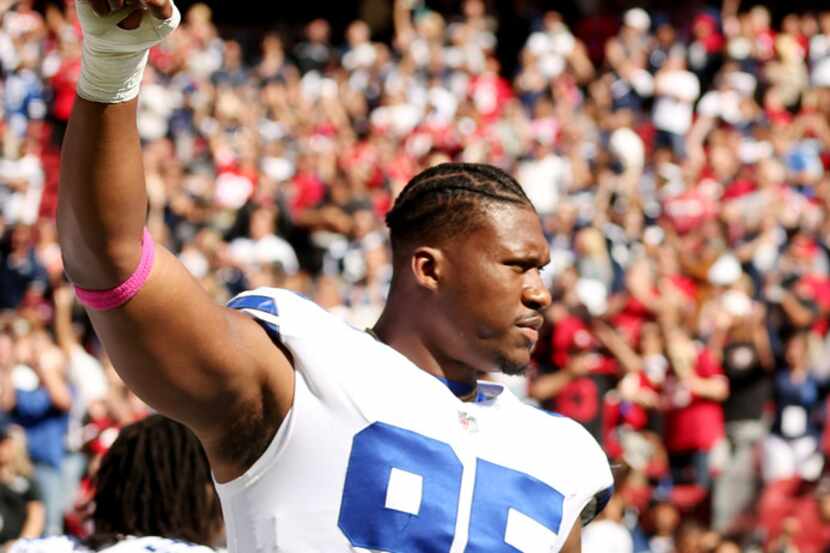 Dallas Cowboys defensive tackle David Irving (95) raises his fist at the conclusion of the...