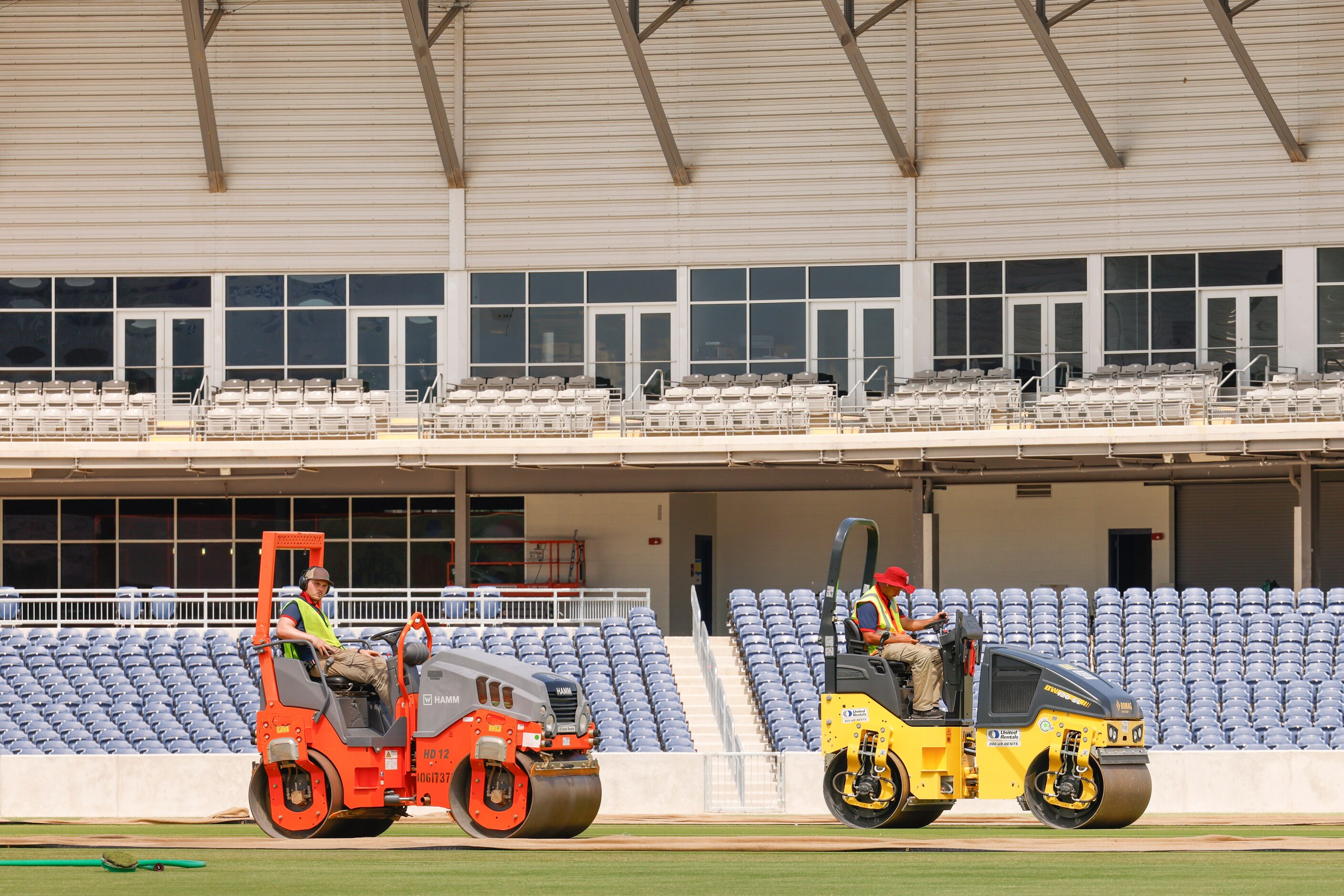 Groundsmen curate a cricket pitch on Thursday, July 6, 2023, at Grand Prairie Stadium, ahead...