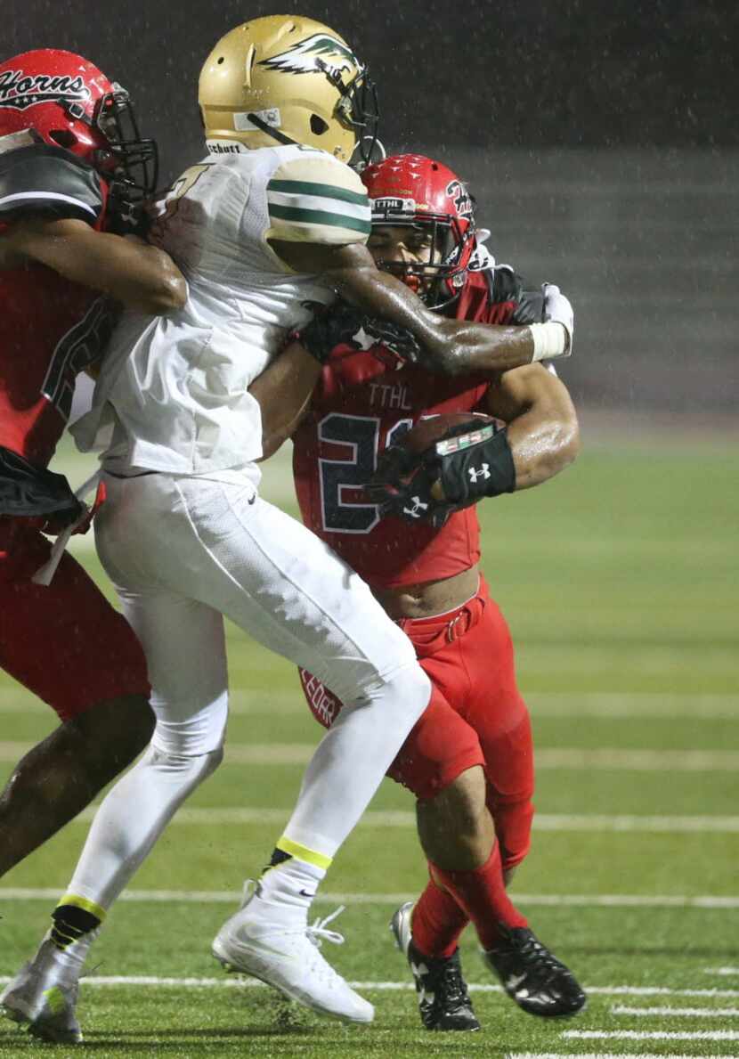 Cedar Hill's Kaegun Williams (24) is tackled by DeSoto's AJ Green (17) during the first half...