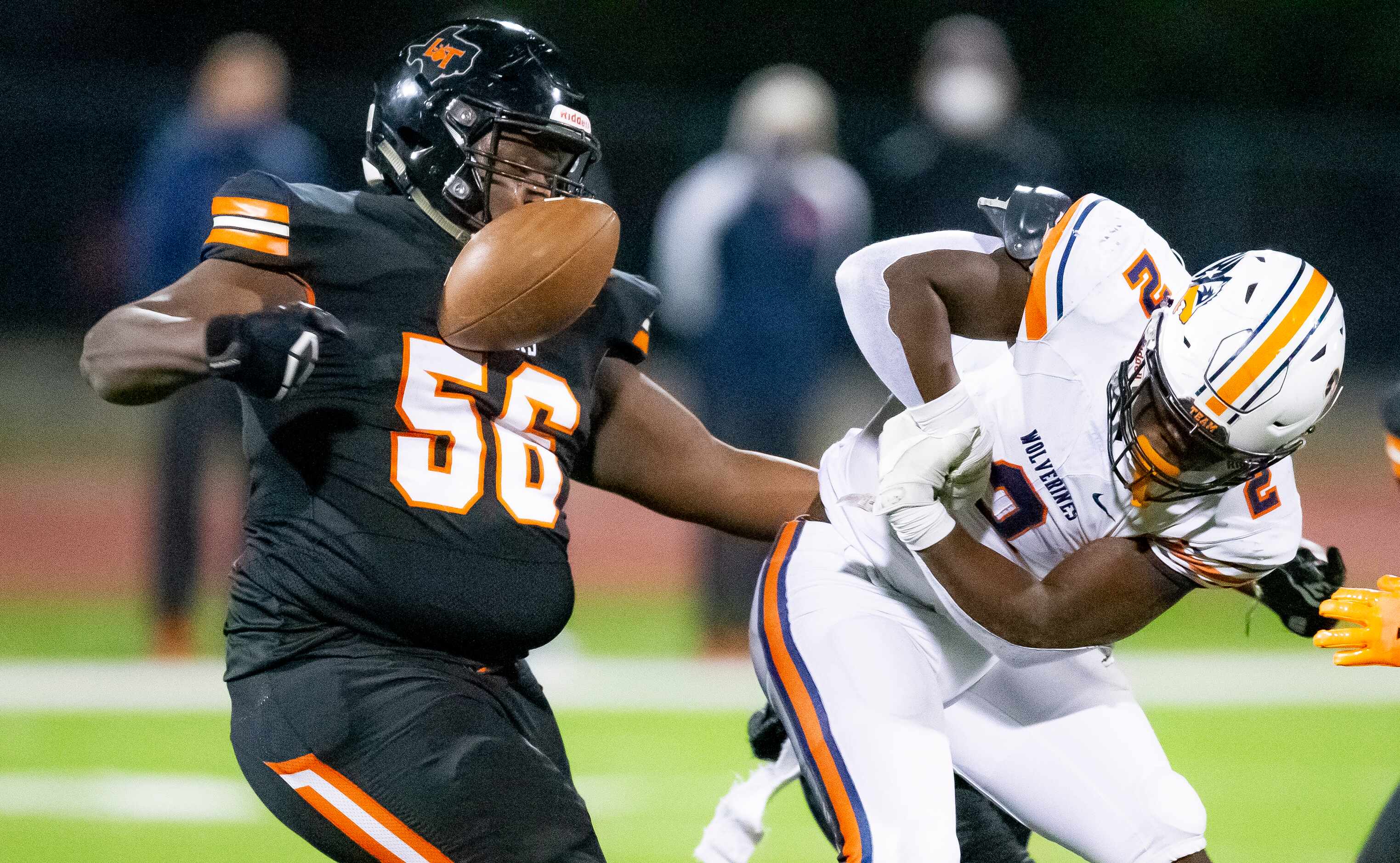 Lancaster junior defensive lineman Thomas Gort III (56) strips the ball from Wakeland junior...