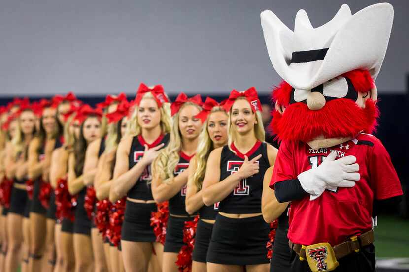 Texas Tech cheerleaders and mascot stand for the national anthem before the Red Raiders'...