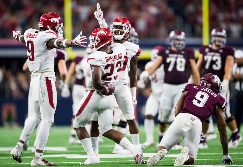 FILE - Arkansas Razorbacks linebacker Dre Greenlaw (23) celebrates with team mates after...