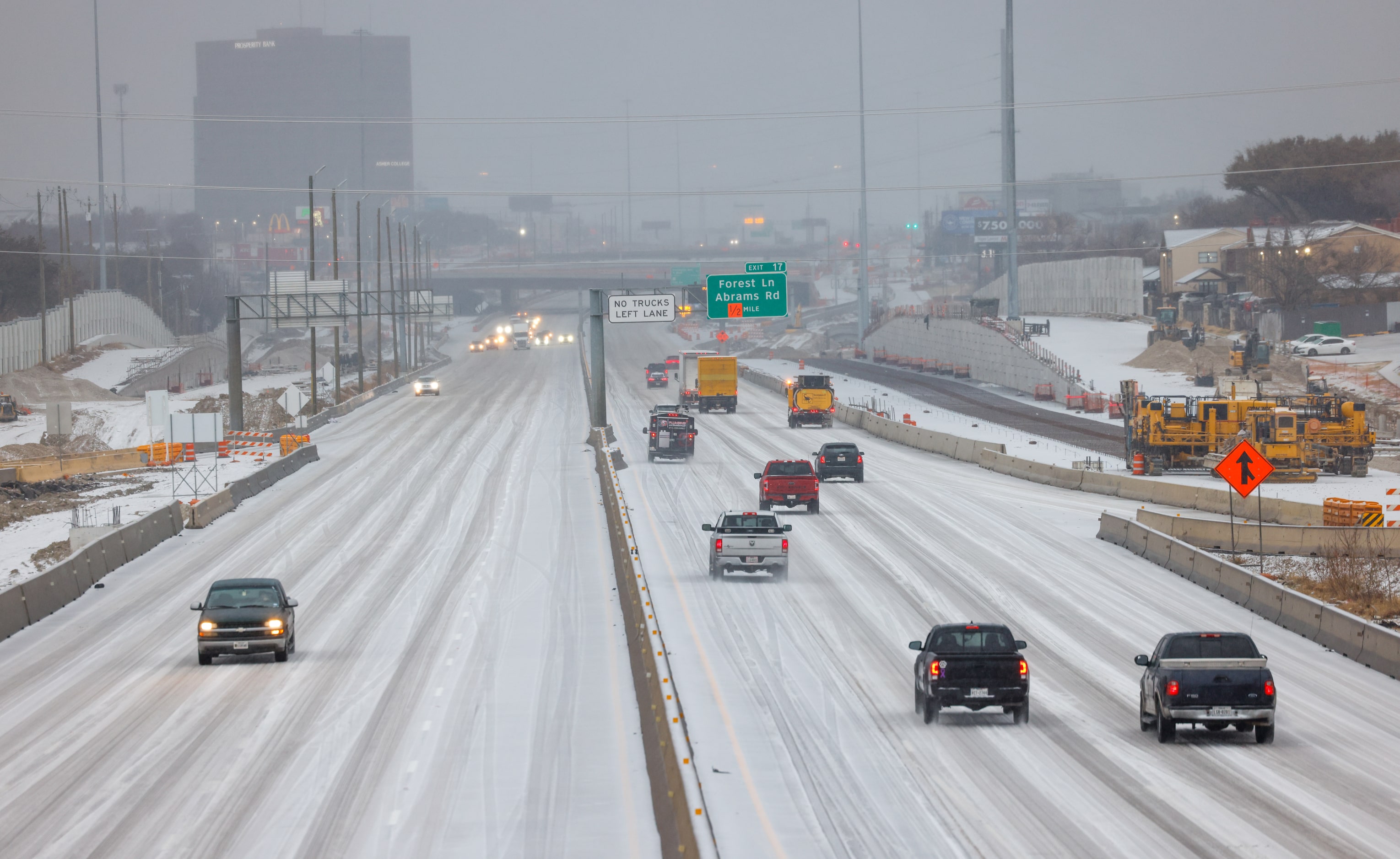 Cars move along icy roads on U.S. 75 near Skillman Street in Dallas on Tuesday, Jan. 31,...