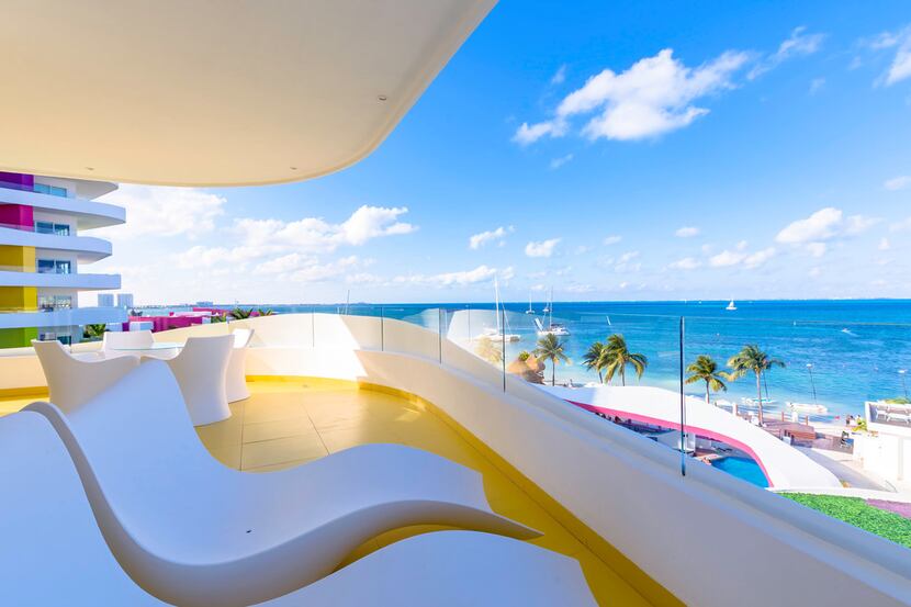 Balconies with sleek, stylish furniture offer views of the Caribbean Sea at Temptation...