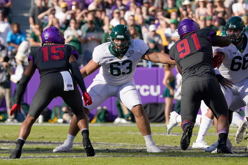 Baylor offensive lineman Grant Miller (63) defends against the rush by TCU safety Josh...