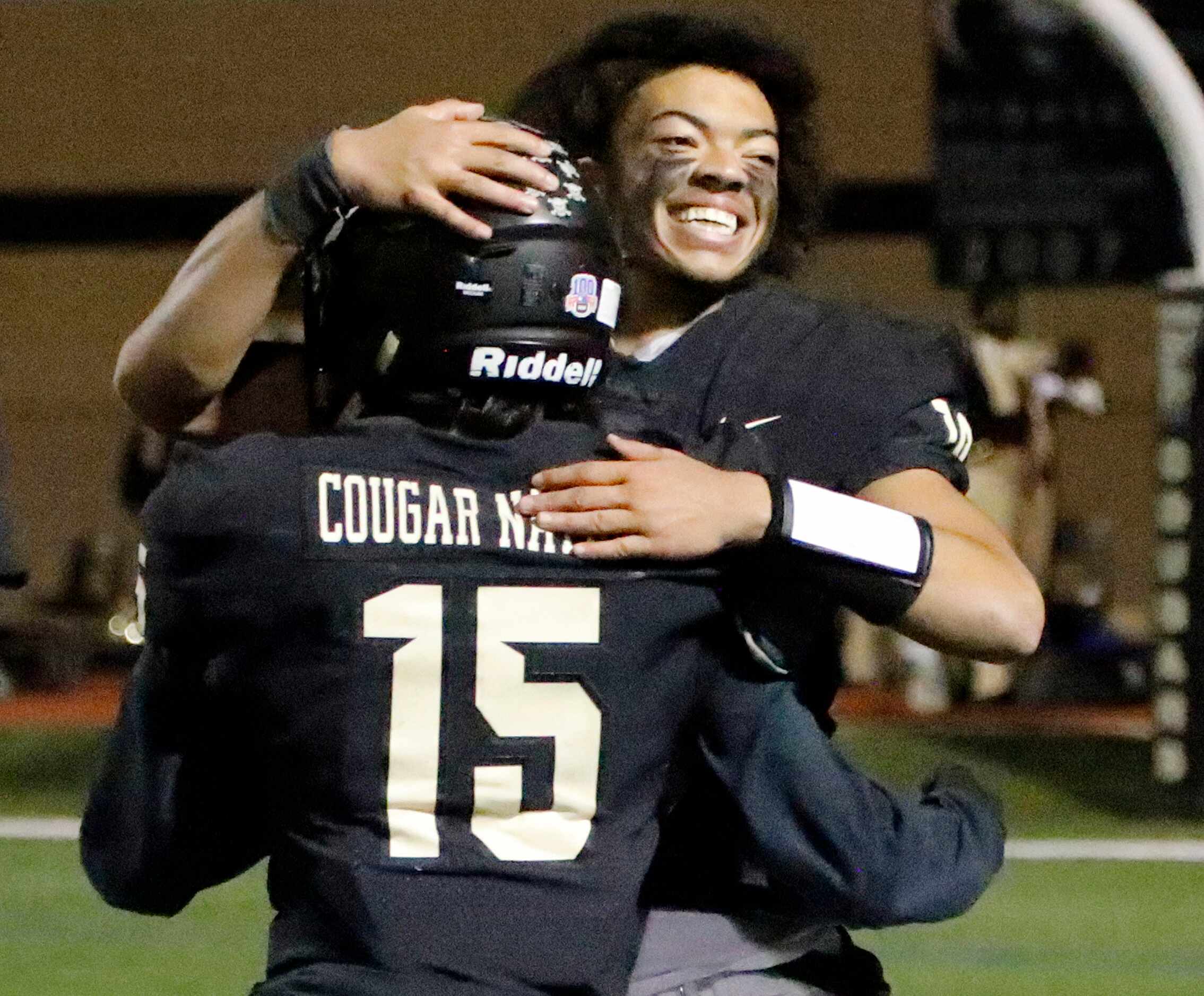 The Colony High School quarterback Jonathan Roberson (19) embraces The Colony High School...