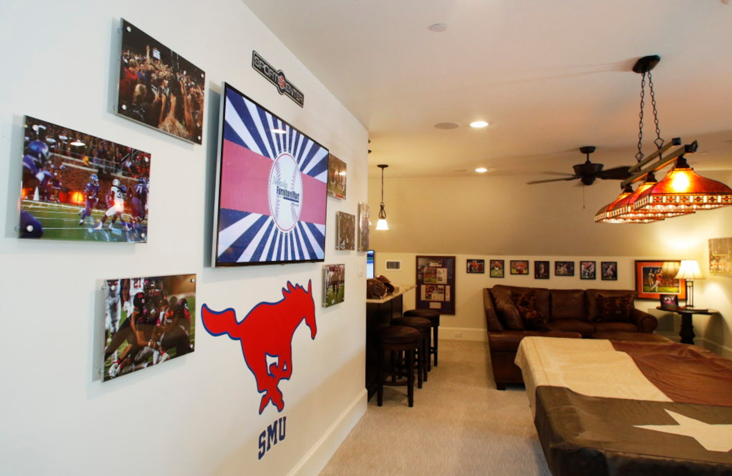 SMU football coach Chad Morris poses for a portrait with his wife, Paula, in their home in...