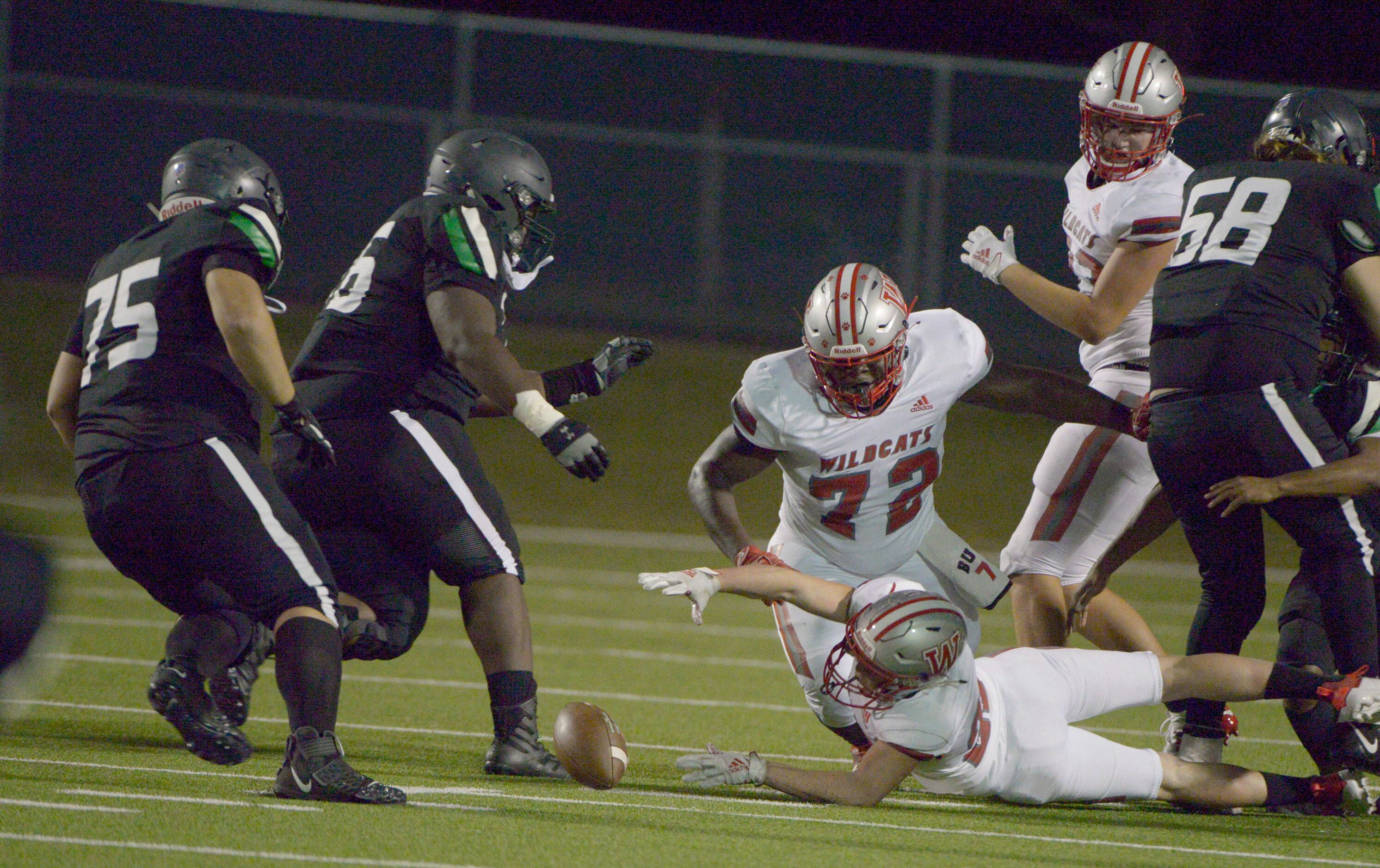 Player scramble for a Berkner fumble that was eventually recovered by Trevor Goosby (75) in...
