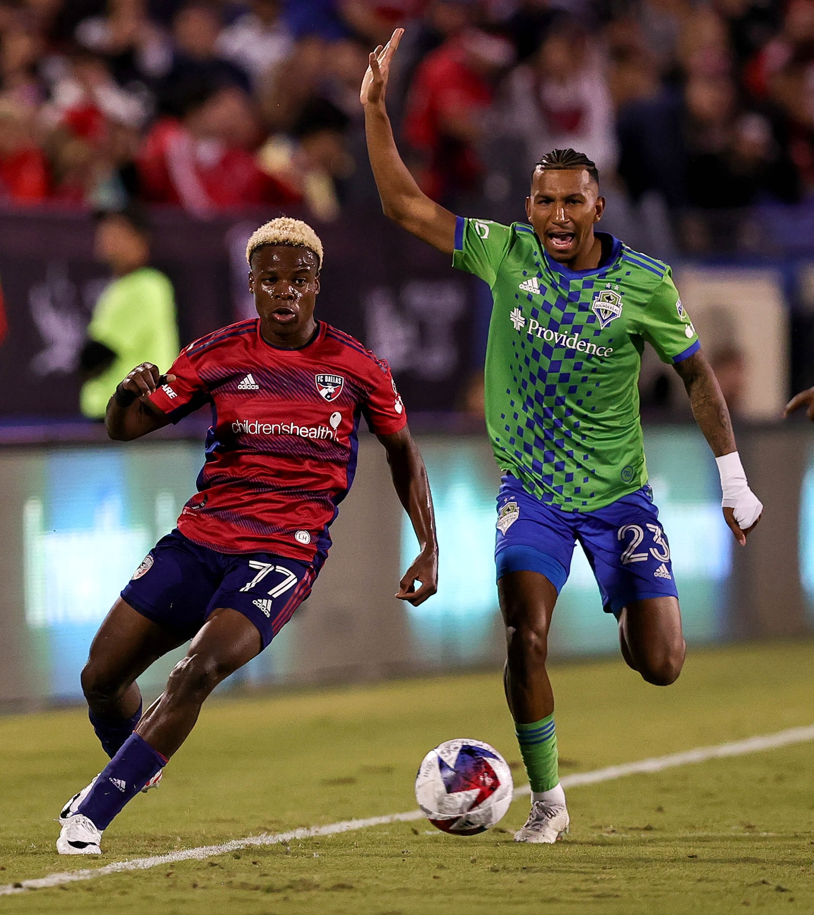 FC Dallas attacker Bernard Kamungo (77) goes for a loose ball against Seattle midfielder Leo...