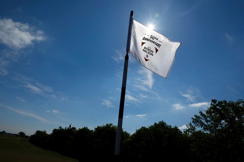 The 50th Anniversary AT&T Byron Nelson golf tournament pin flag whips in the wind at the new...