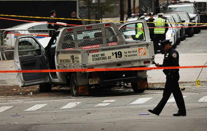 The crashed vehicle used in what is being described as a terrorist attack sits in lower...