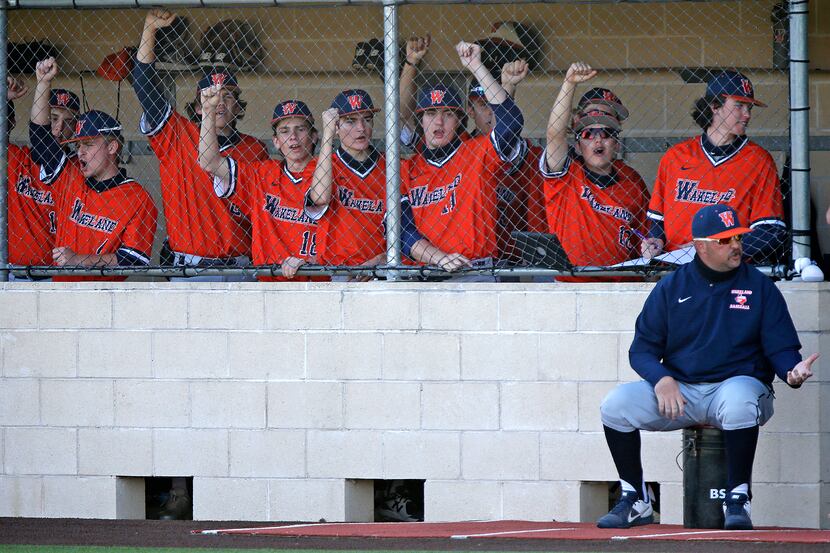 The Wakeland dugout cheers during the fifth inning as Heritage High School hosted Wakeland...
