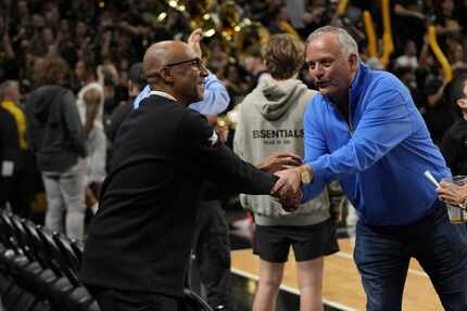 Central Florida head coach Johnny Dawkins, left, is congratulated by a fan as he leaves the...