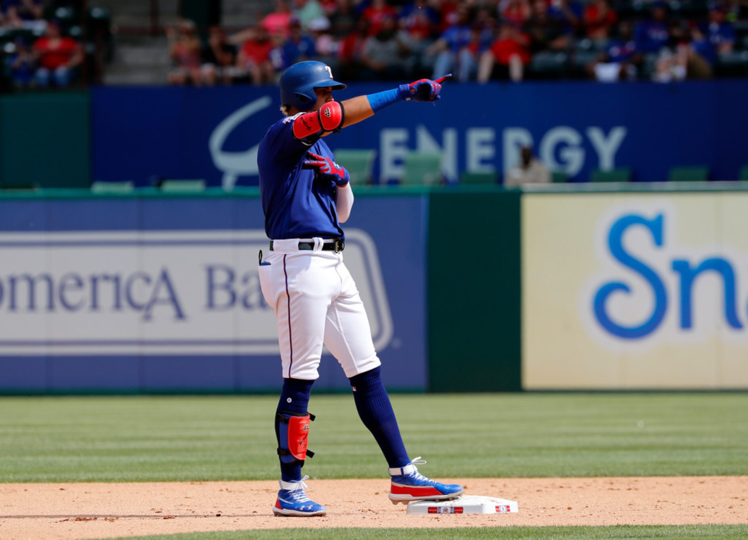 Texas Rangers' Ronald Guzman gestures to the dugout after hitting a double off of Kansas...