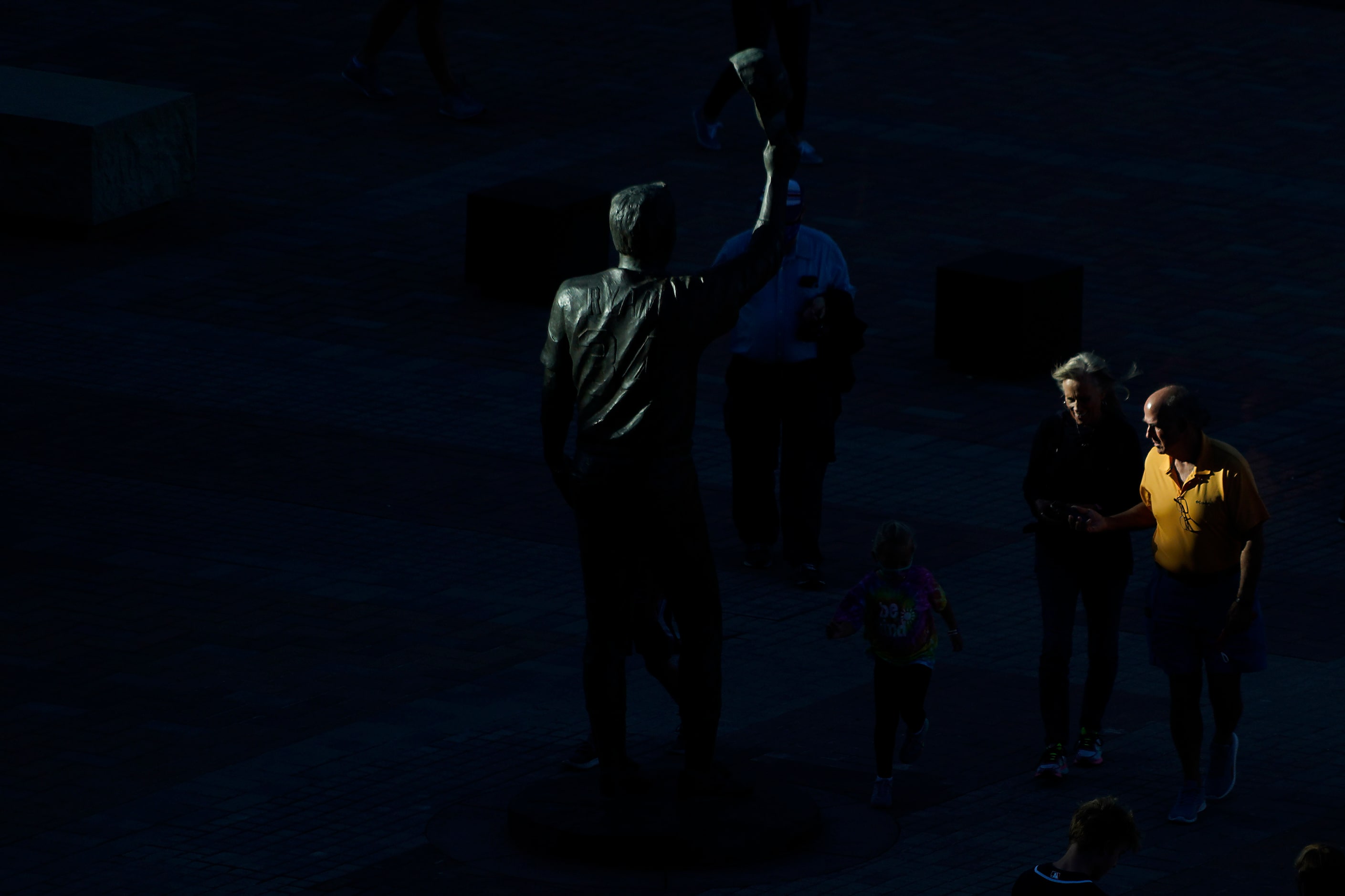 Fans pass a statue of Nolan Ryan as the enter the stadium before Game 1 of a National League...