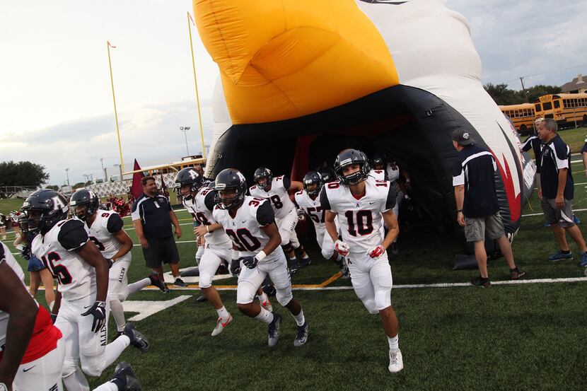 The Allen Eagles football team takes the field before kickoff as Plano High School hosted...