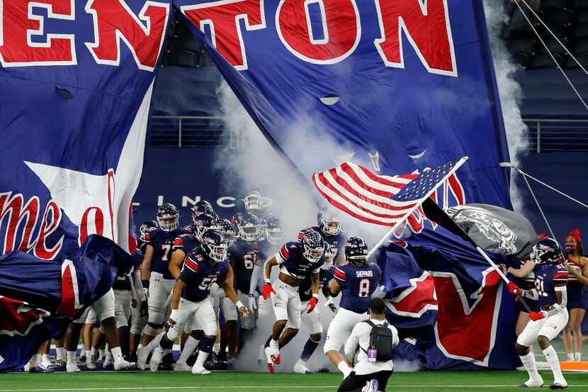 The Denton Ryan football team enters the field before the first half of the Class 5A...