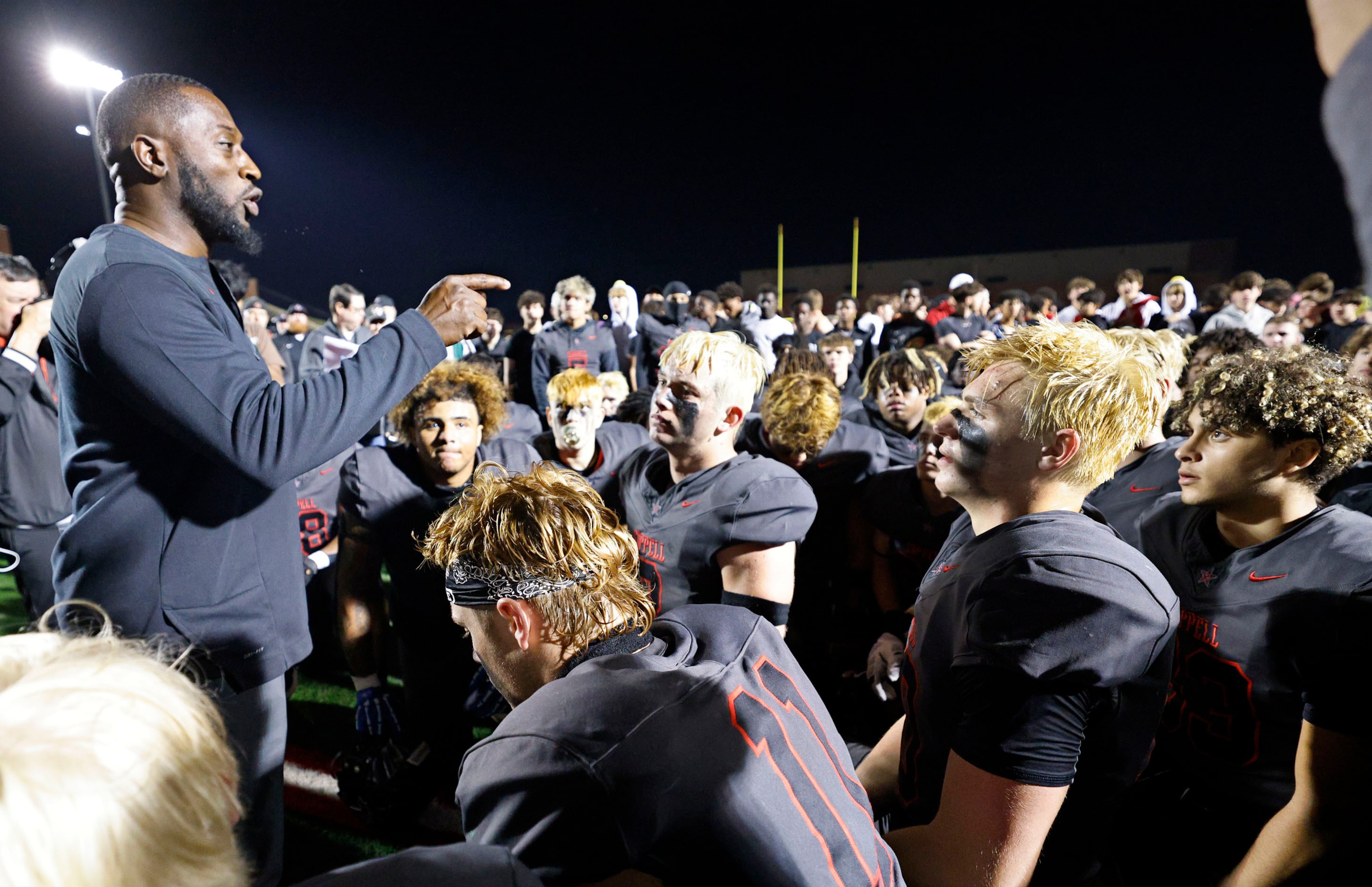 Coppell head coach Antonio Wiley, left, speaks to his players after their 35-27 victory...