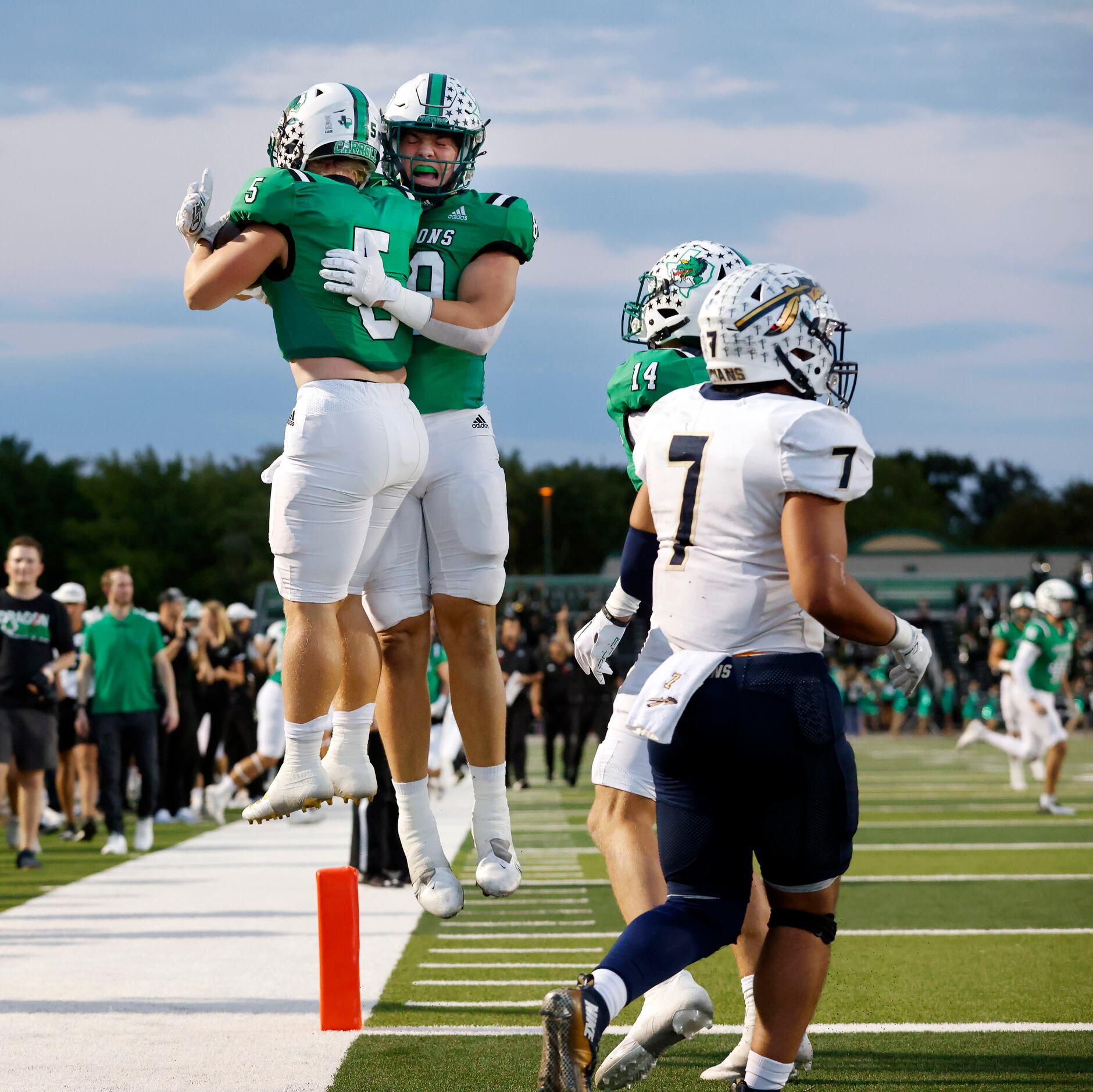 Southlake Carroll running back James Lehman (5) is congratulated by tight end Harrison Moore...