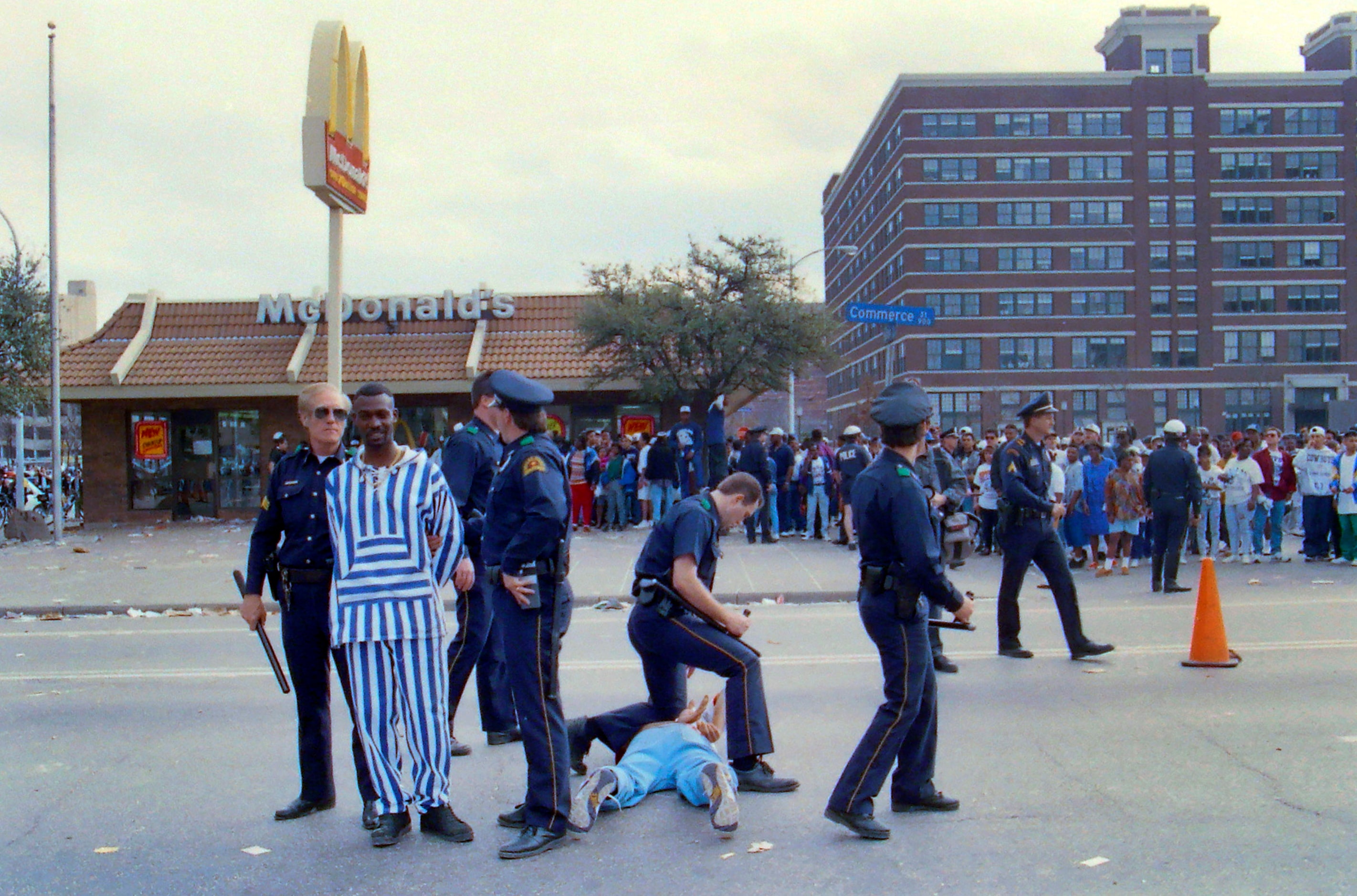 Dallas police arrest young men outside the downtown McDonald's during following the Dallas...