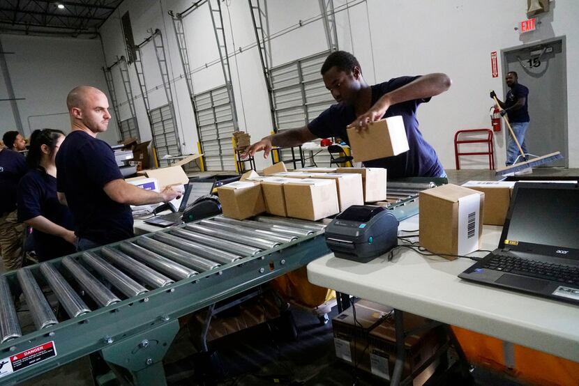 Frank Codispoti and Dupree Nobles prepare packages at ShipBob in Grapevine, November 2,...