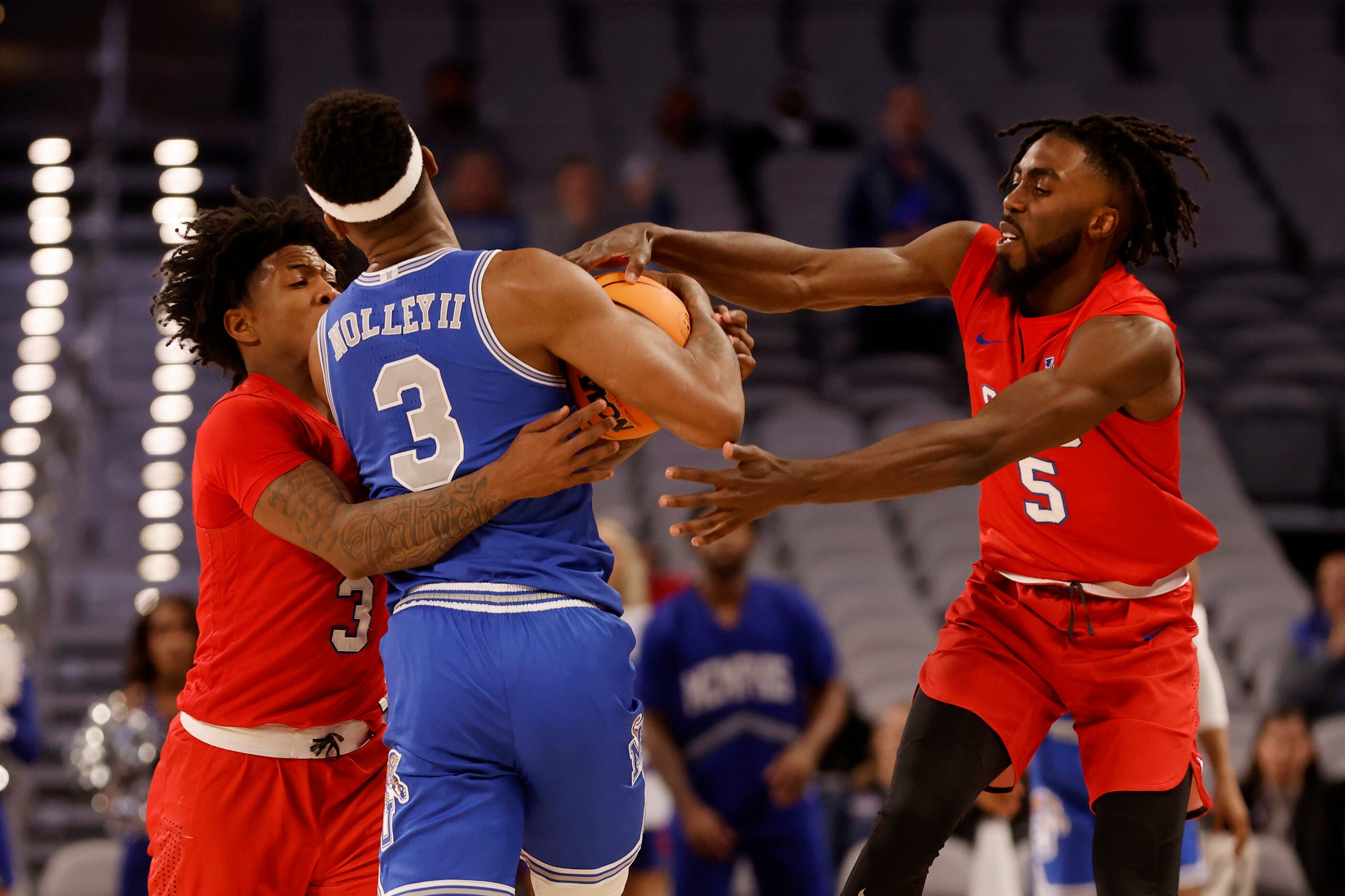 SMU guard Kendric Davis (3) and guard Emmanuel Bandoumel (5) defend Memphis guard Landers...