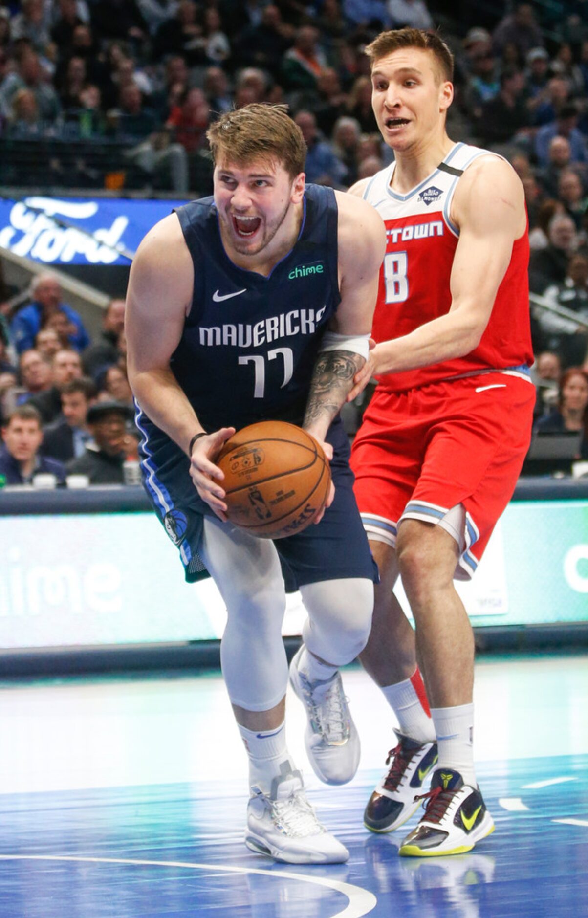 Dallas Mavericks guard Luka Doncic (77) reacts while going up for a shot past Sacramento...