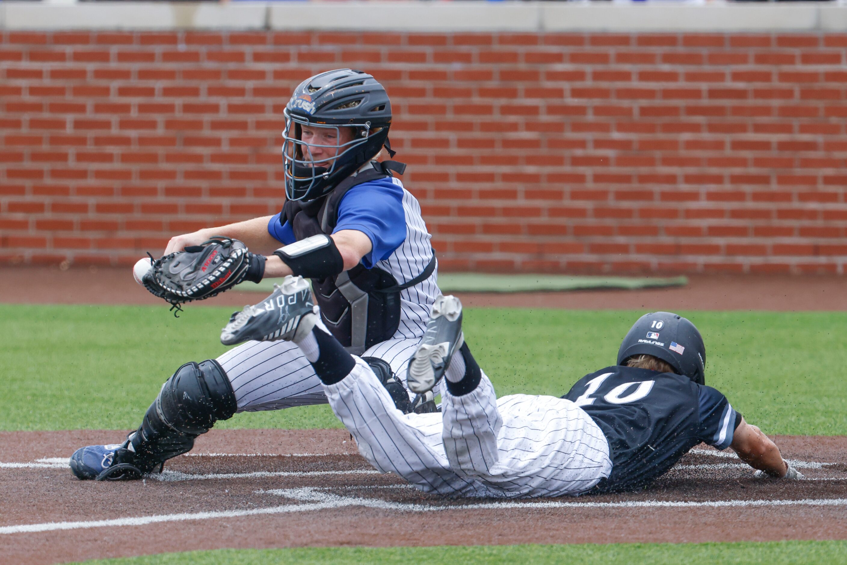 Byron Nelson High School catcher Carson Packan (back) misses to catch as Denton Guyer’s...