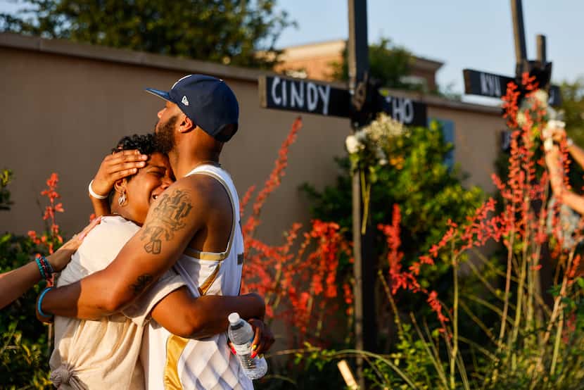Robert Jackson (right) comforts his mother Cheryl Jackson of Allen, as she breaks down in...