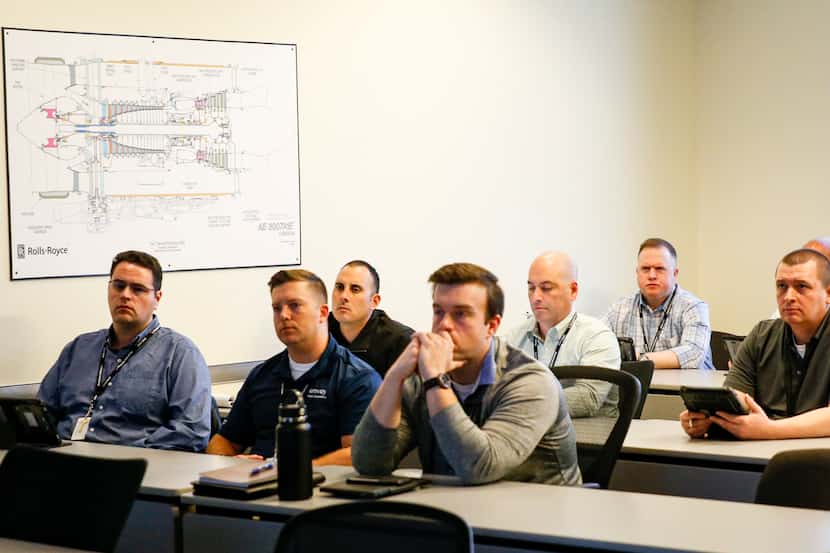 A class of pilots listens to ground school instructor Mark Stewart teach at Envoy Airlines...