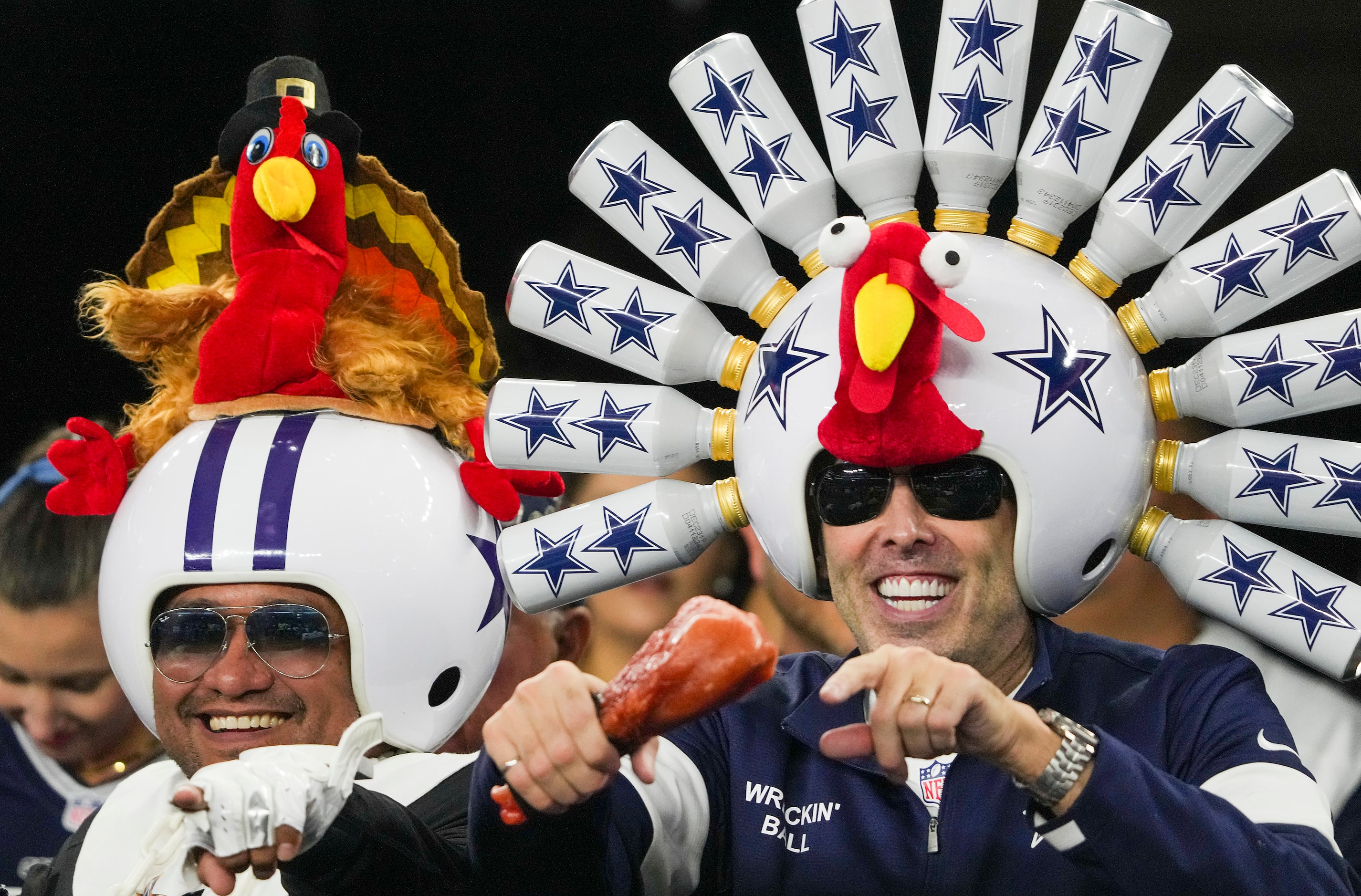 Dallas Cowboys fan Gregg Wilson, wearing his “Wrecking Ball” helmet for Thanksgiving, cheers...