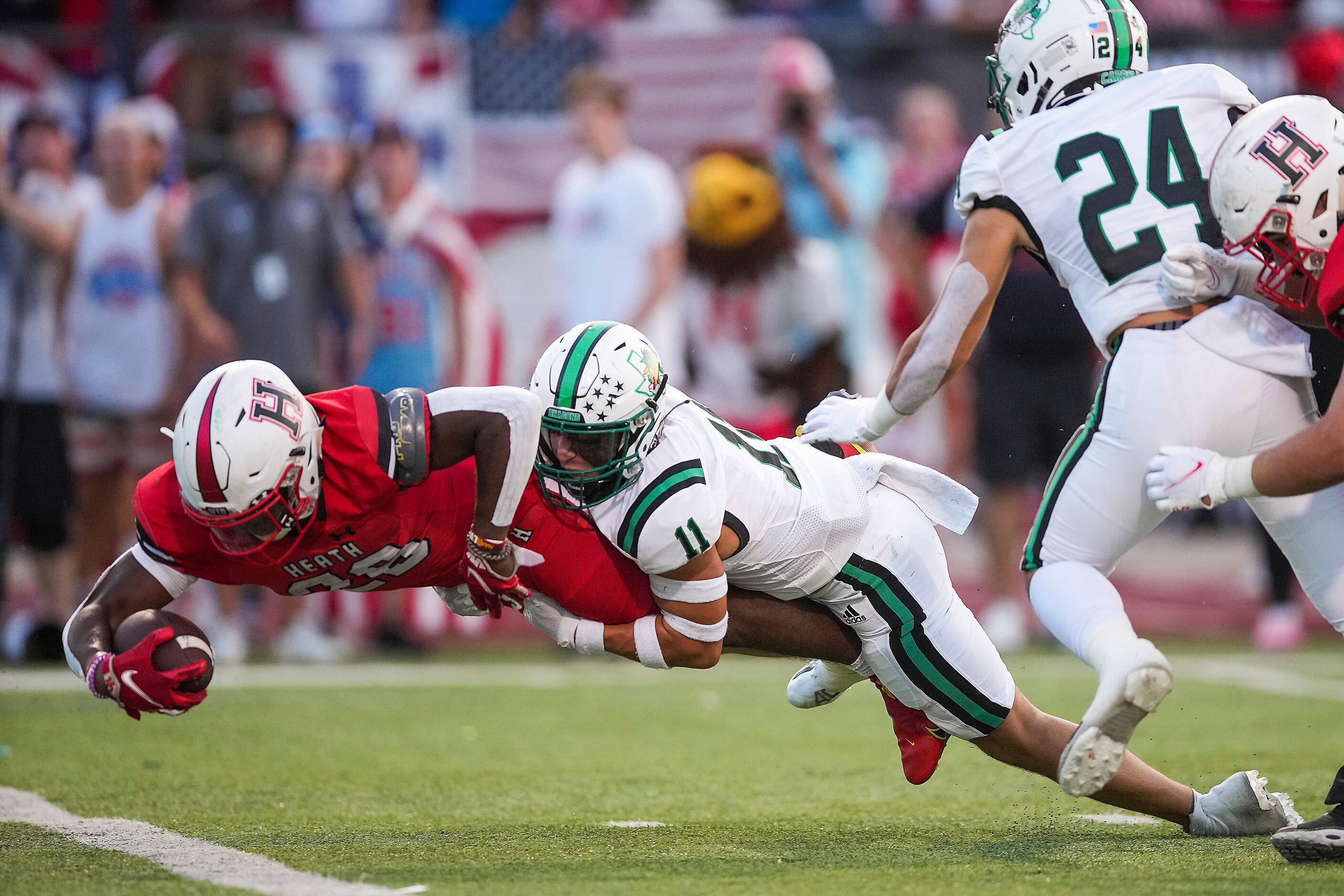 Rockwall-Heath running back Zach Evans (26) scores on a 12-yard touchdown run pas Southlake...