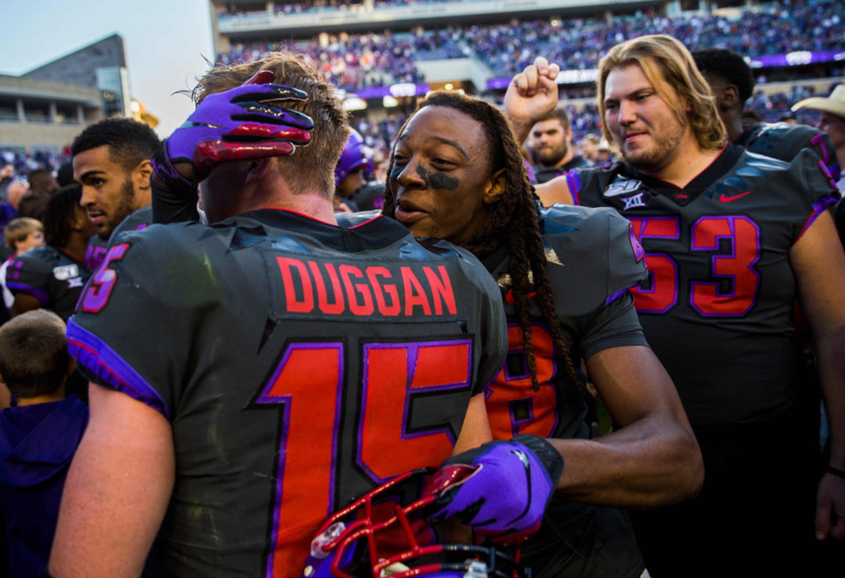 TCU Horned Frogs quarterback Max Duggan (15) gets a hug from cornerback Caleb Biggurs (48)...