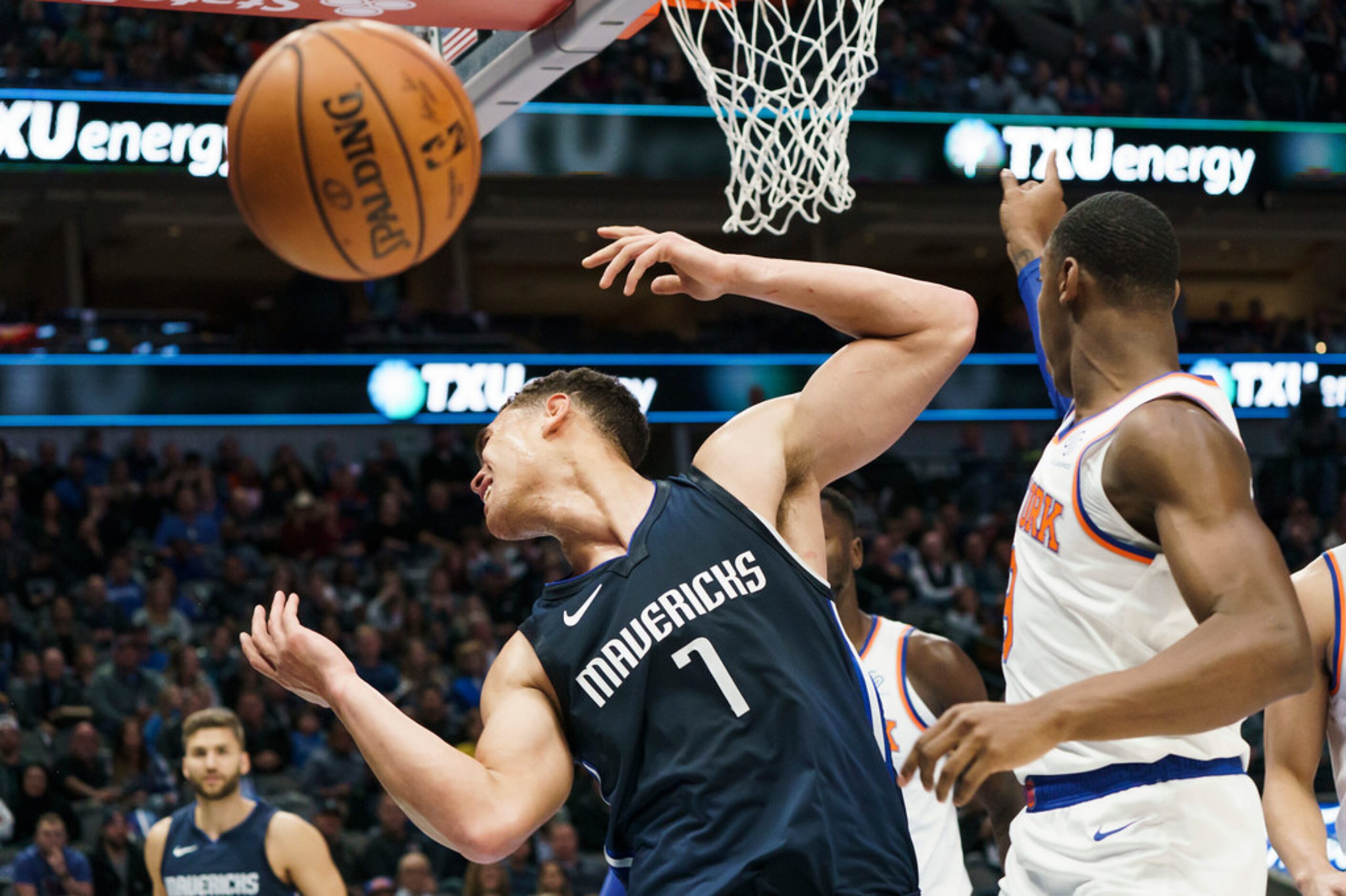 Dallas Mavericks forward Dwight Powell (7) is fouled by New York Knicks guard RJ Barrett (9)...