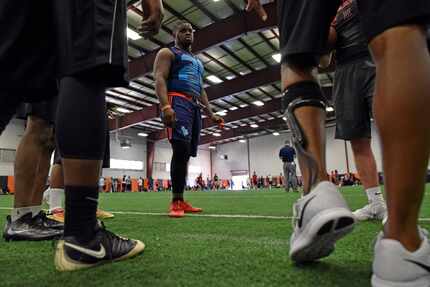 Mesquite Horn High School senior linebacker Chika Nwabuko surrounded by a group of friends...