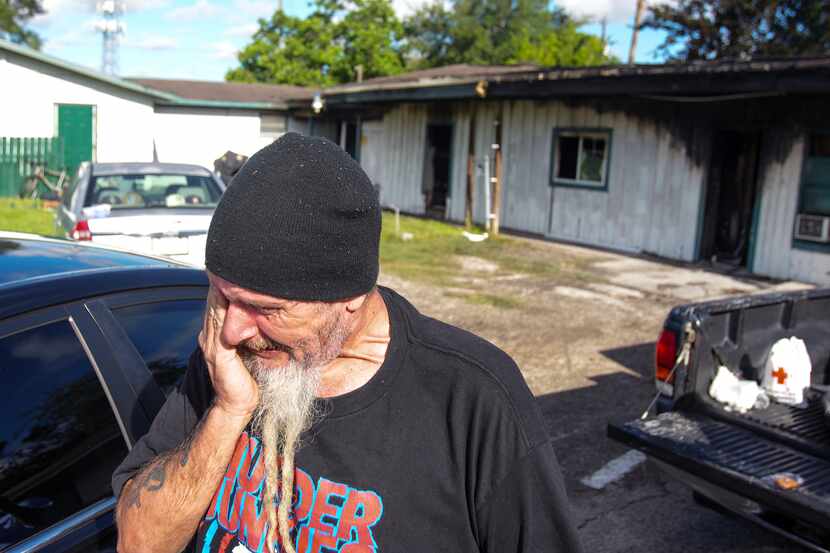 Robin Ahrens, a resident of a multi-room renting facility, reacts to a fatal shooting at the...