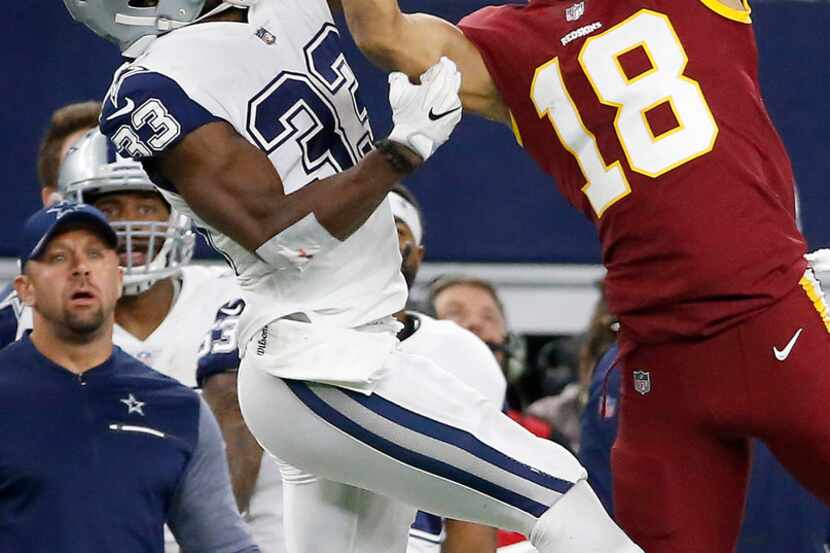 Dallas Cowboys cornerback Chidobe Awuzie (33) breaks up a pass intended for Washington...