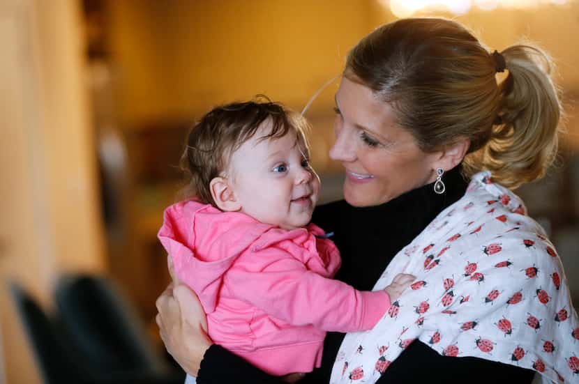 Jenny Boucek shares a smile with her 4-month-old daughter, Rylie, at her home in Dallas on...