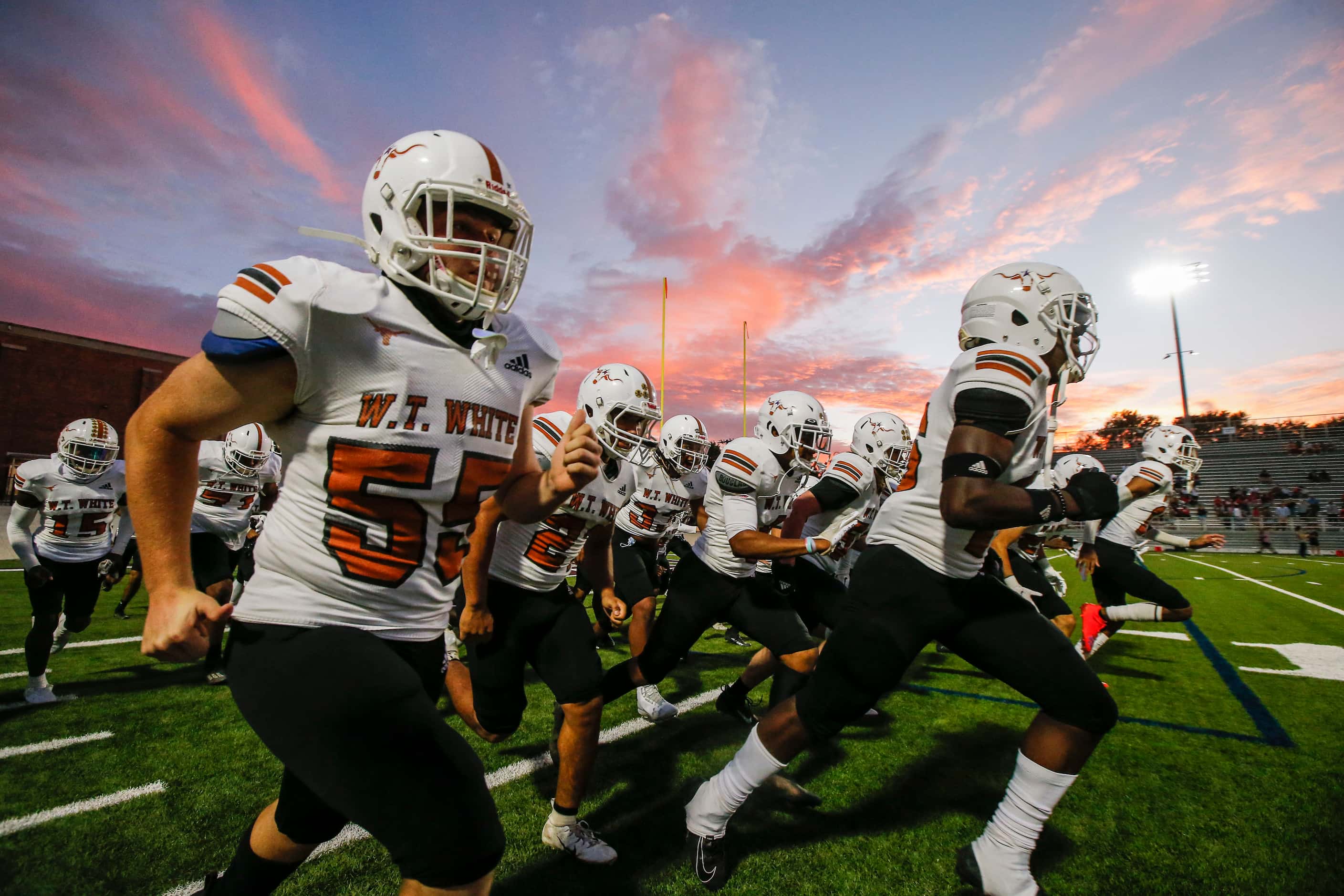 W. T.  White runs onto the field for the first half of a high school football game against...