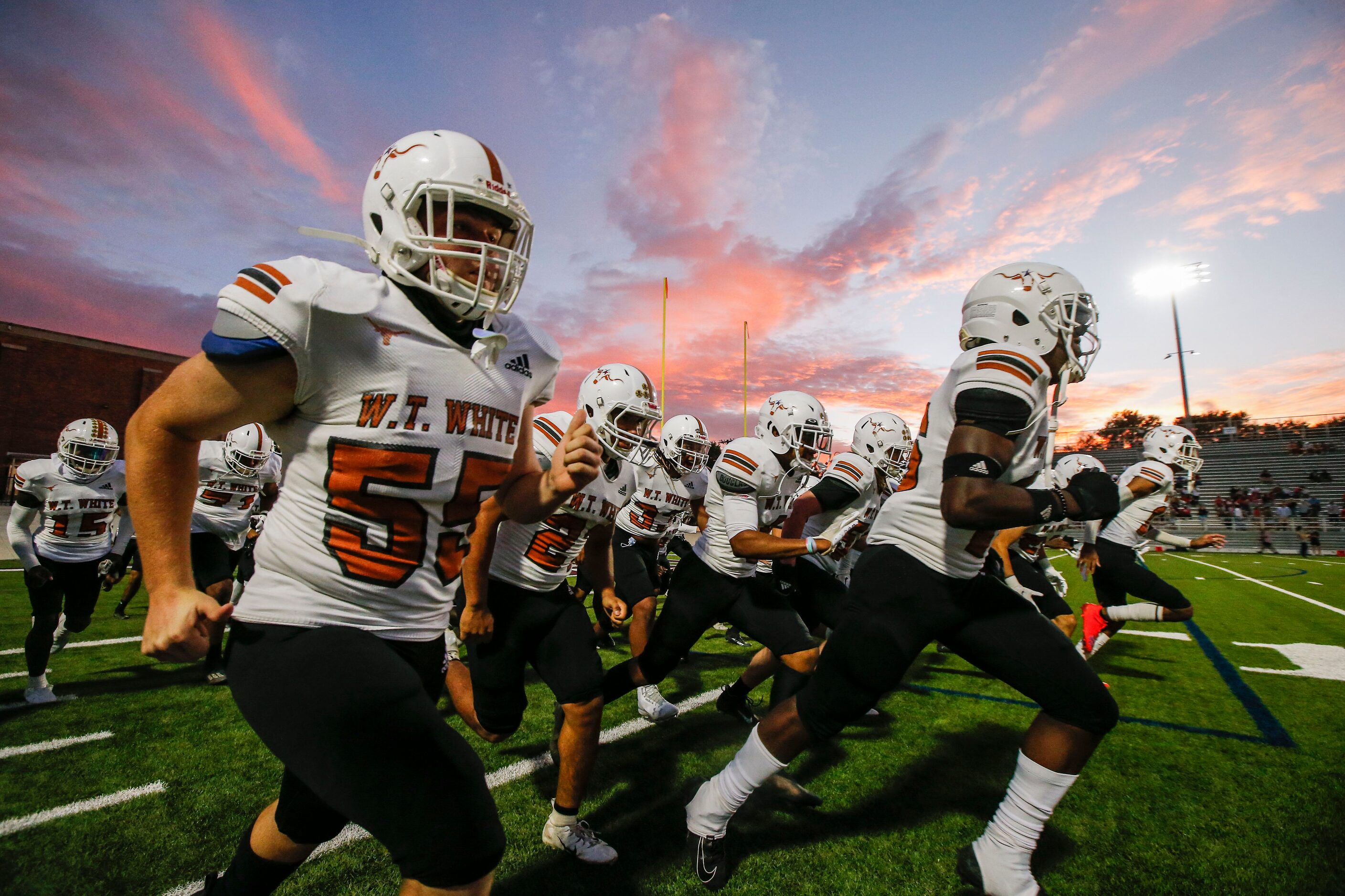 W. T.  White runs onto the field for the first half of a high school football game against...