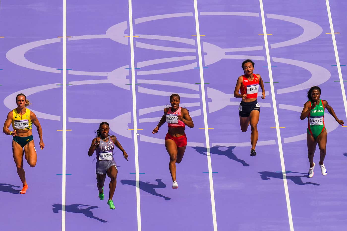 Sha'carri Richardson of the United States (second from left) leads the field on her way to...