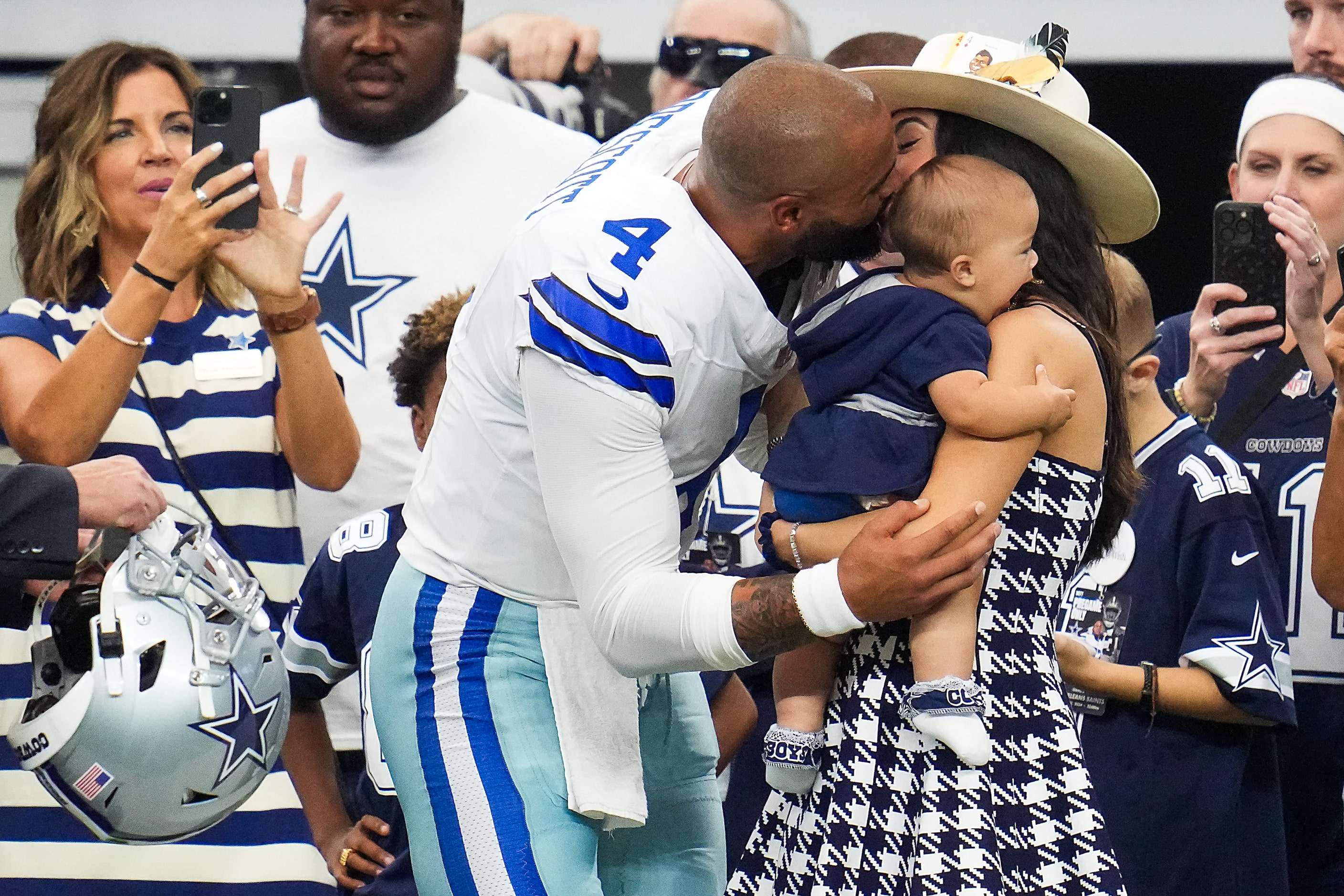 Dallas Cowboys quarterback Dak Prescott kisses his girlfriend Sarah Jane Ramos and their...