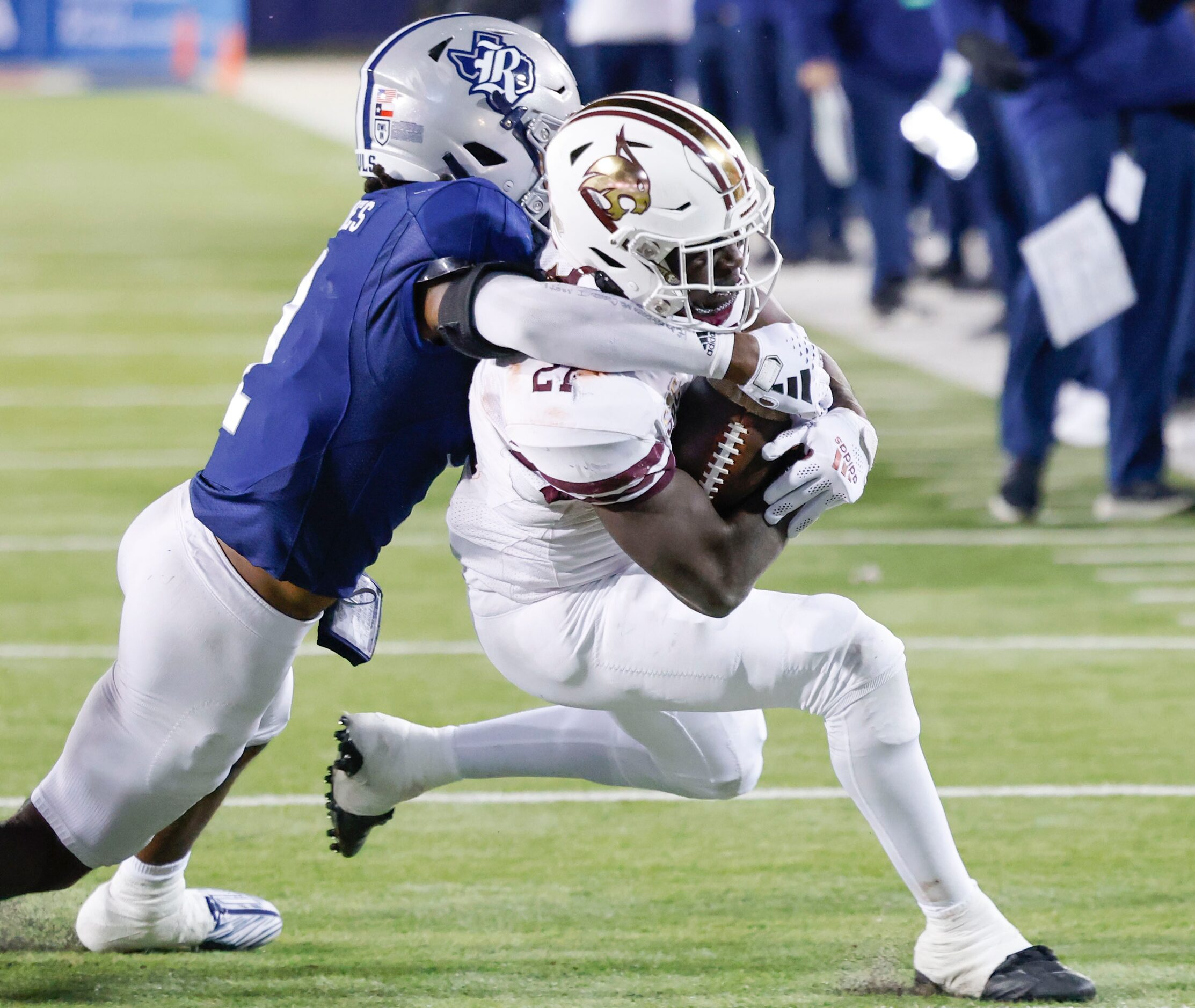 Rice cornerback Tre'shon Devones (2) tackles Texas State running back Ismail Mahdi (21)...