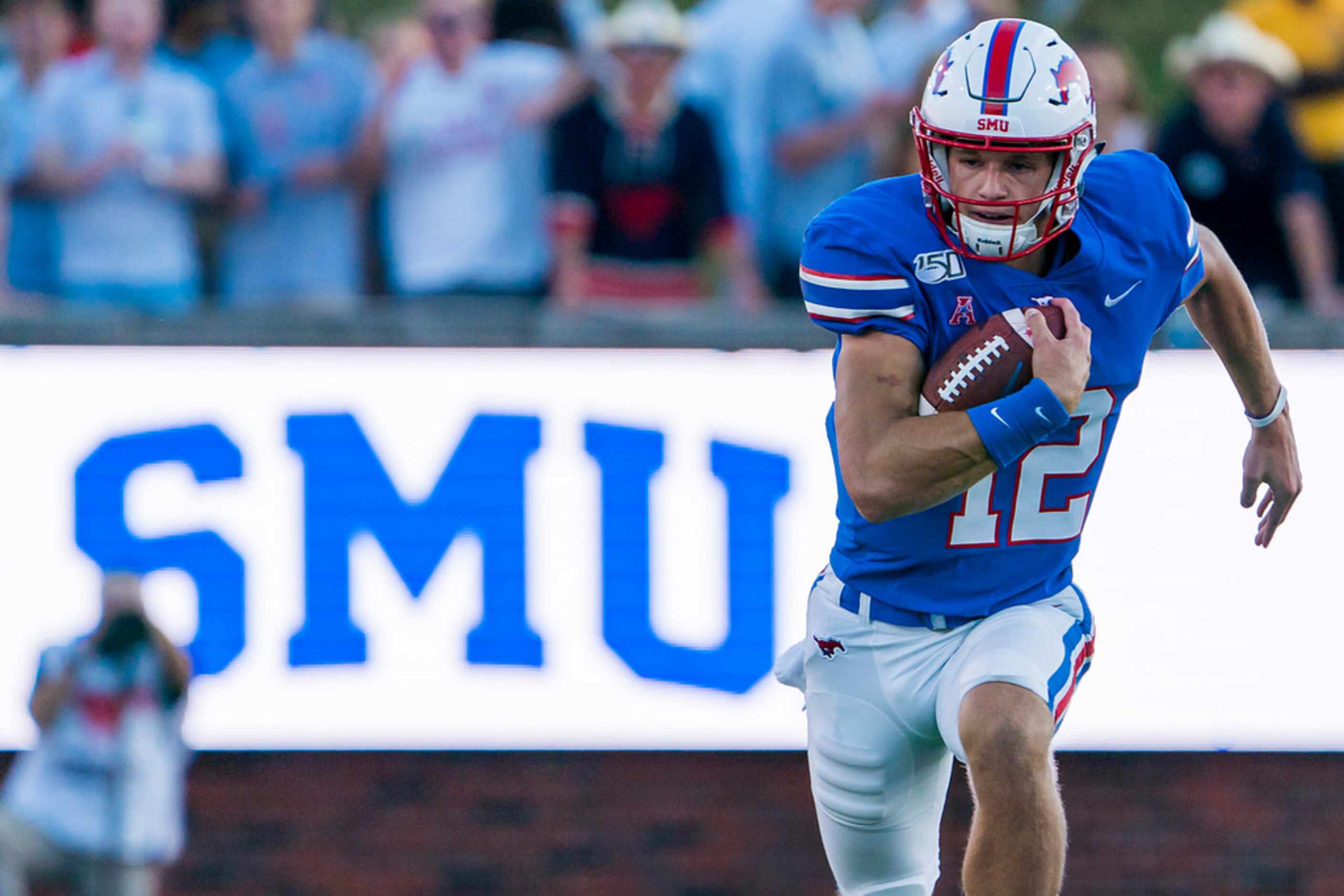 SMU quarterback Derek Green (12) scambles for a first down during the second half of an NCAA...