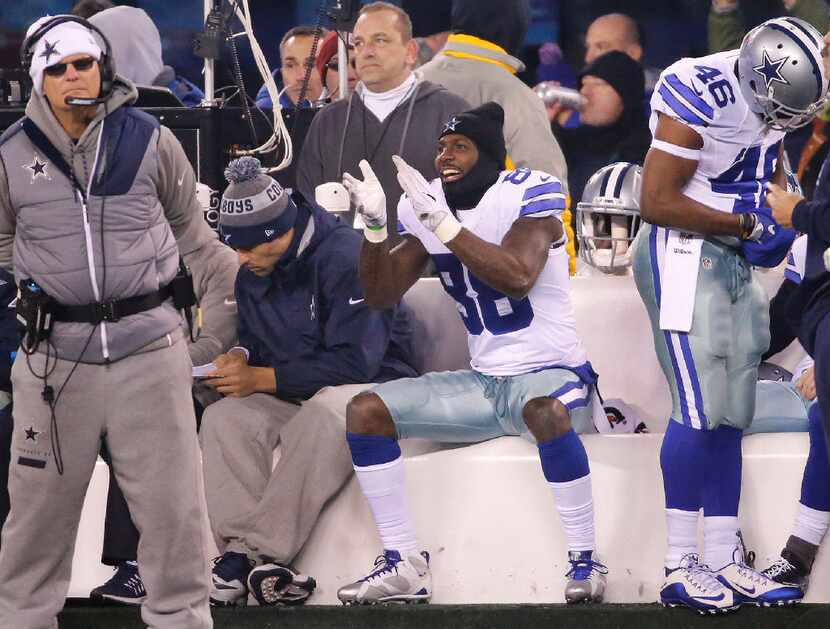 Dallas Cowboys wide receiver Dez Bryant (88) applauds the play of his teammates as he sits...
