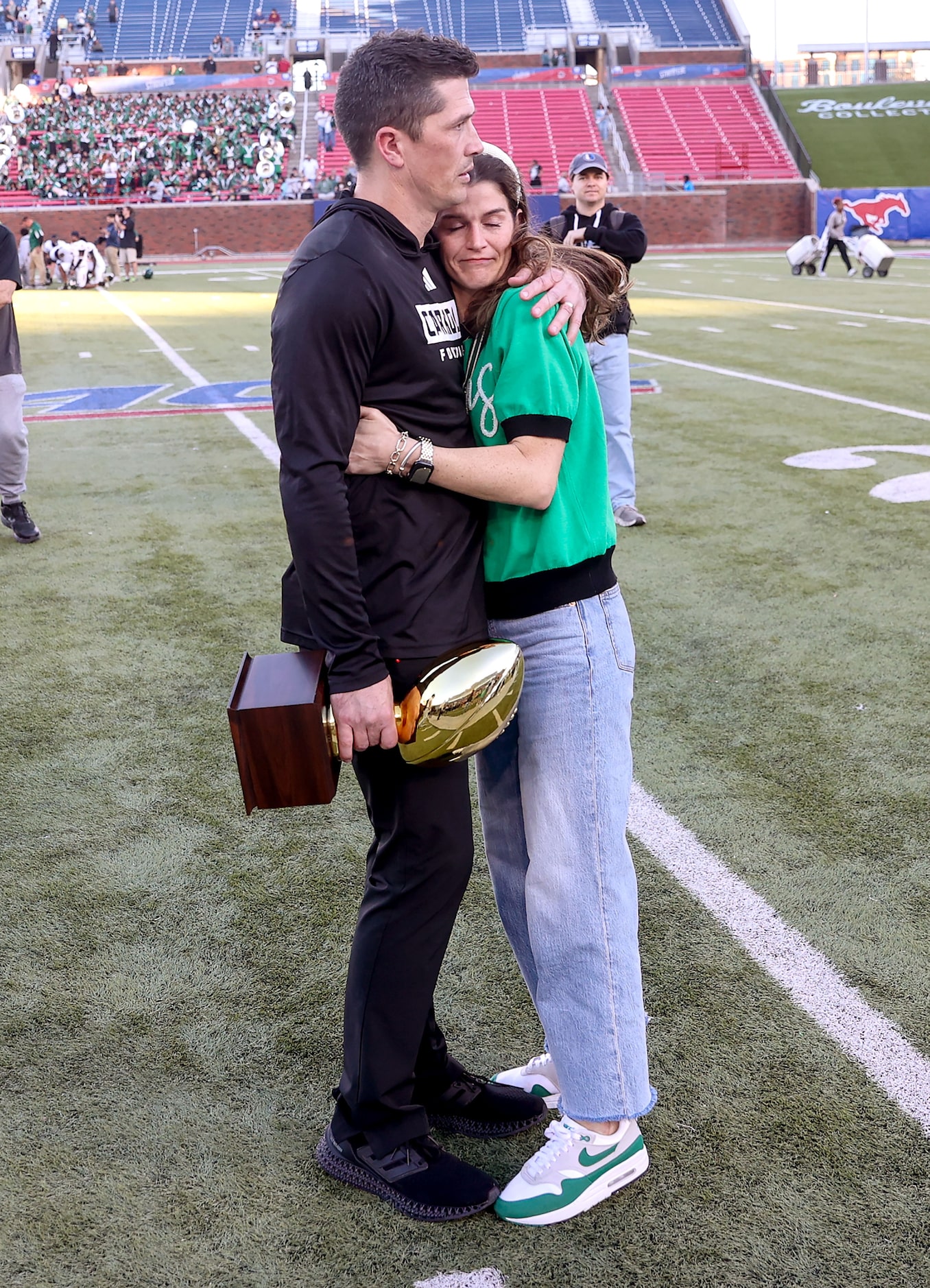 Southlake Carroll head coach Riley Dodge gives a hug to his wife Alexis after defeating...