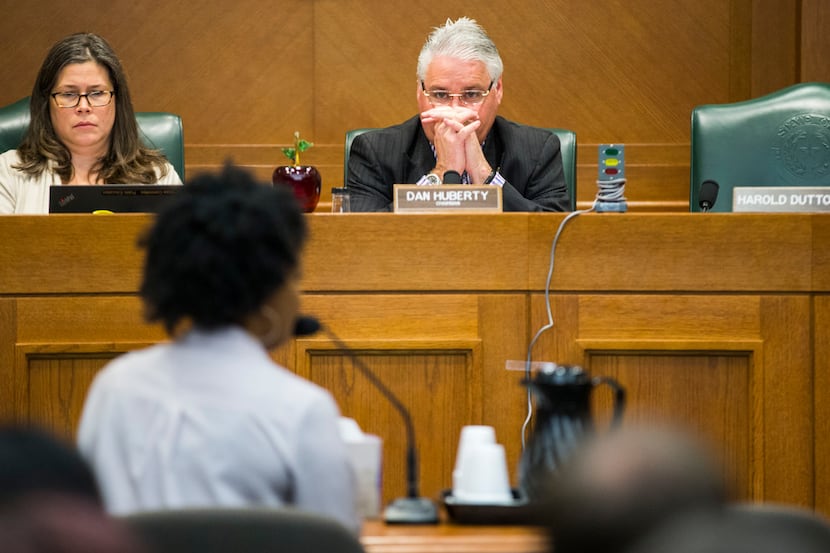 Rep. Dan Huberty (center) listened to Sakennia Reed, a seventh-grade English and language...