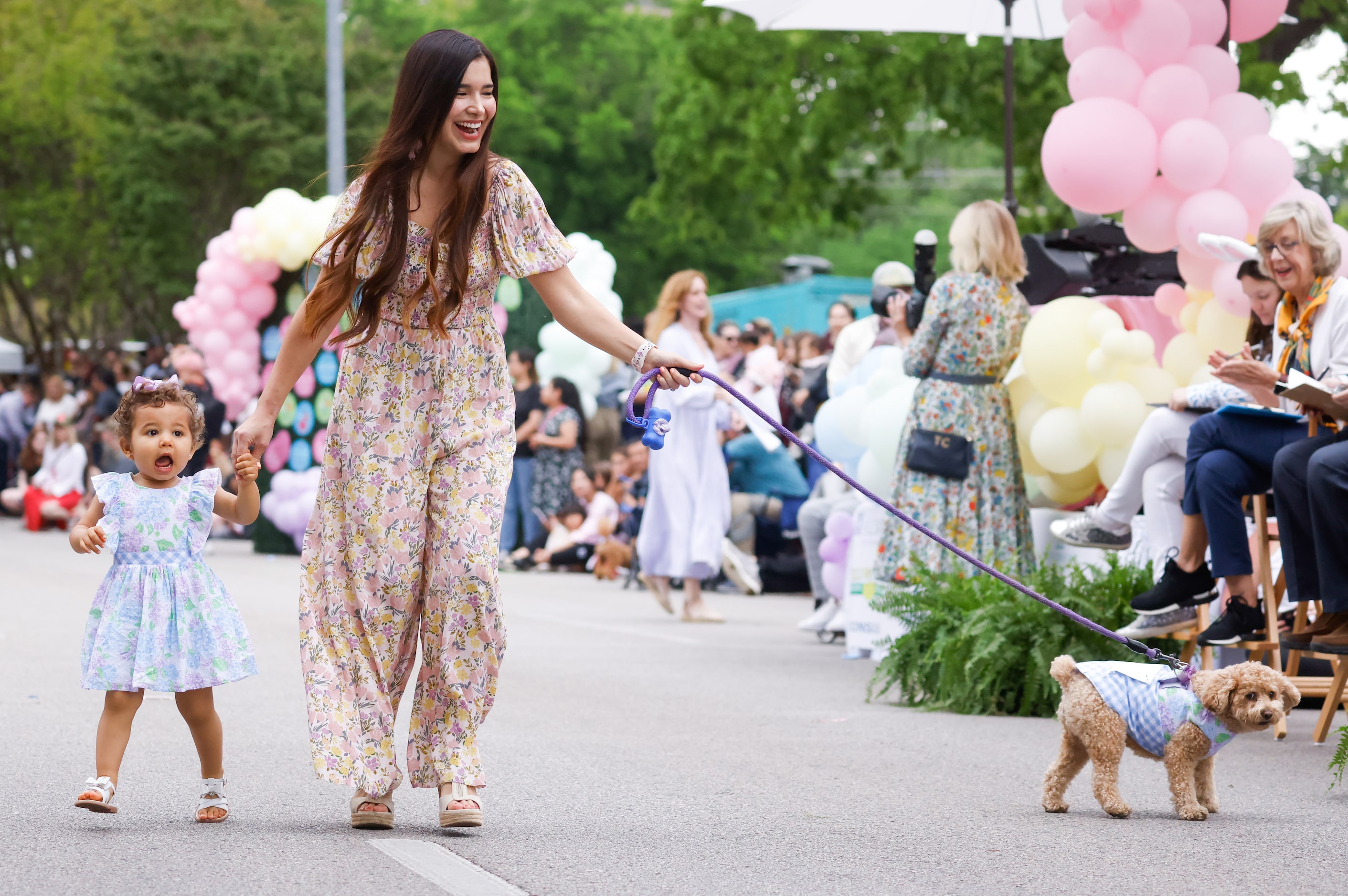 Matching Pooch Parade contestants pass by judges as they make their way down Turtle Creek...