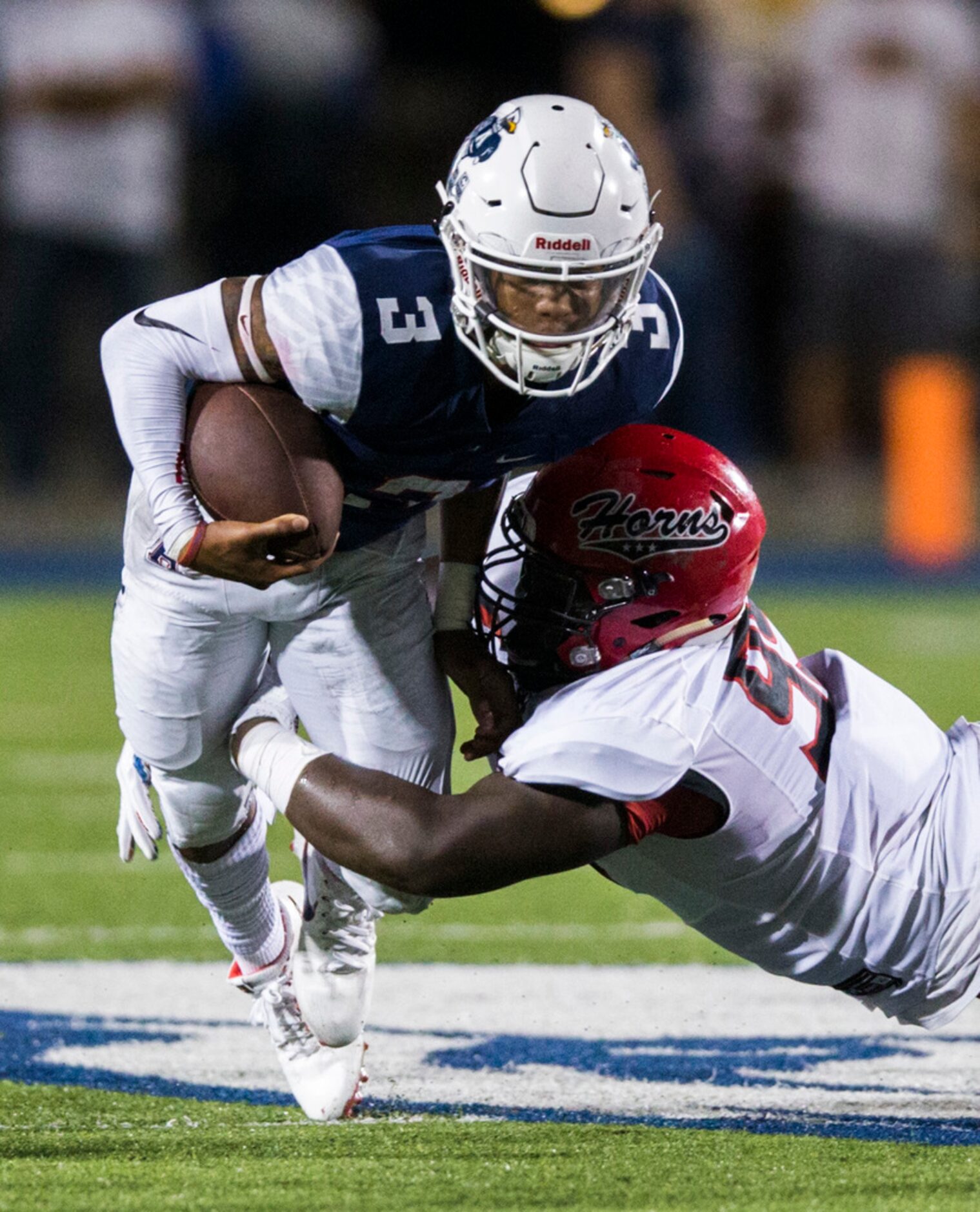 Allen quarterback Raylen Sharpe (3) is tackled by Cedar Hill defensive tackle Leon Young...